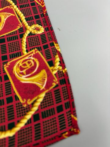 Red scarf with gold french horn design