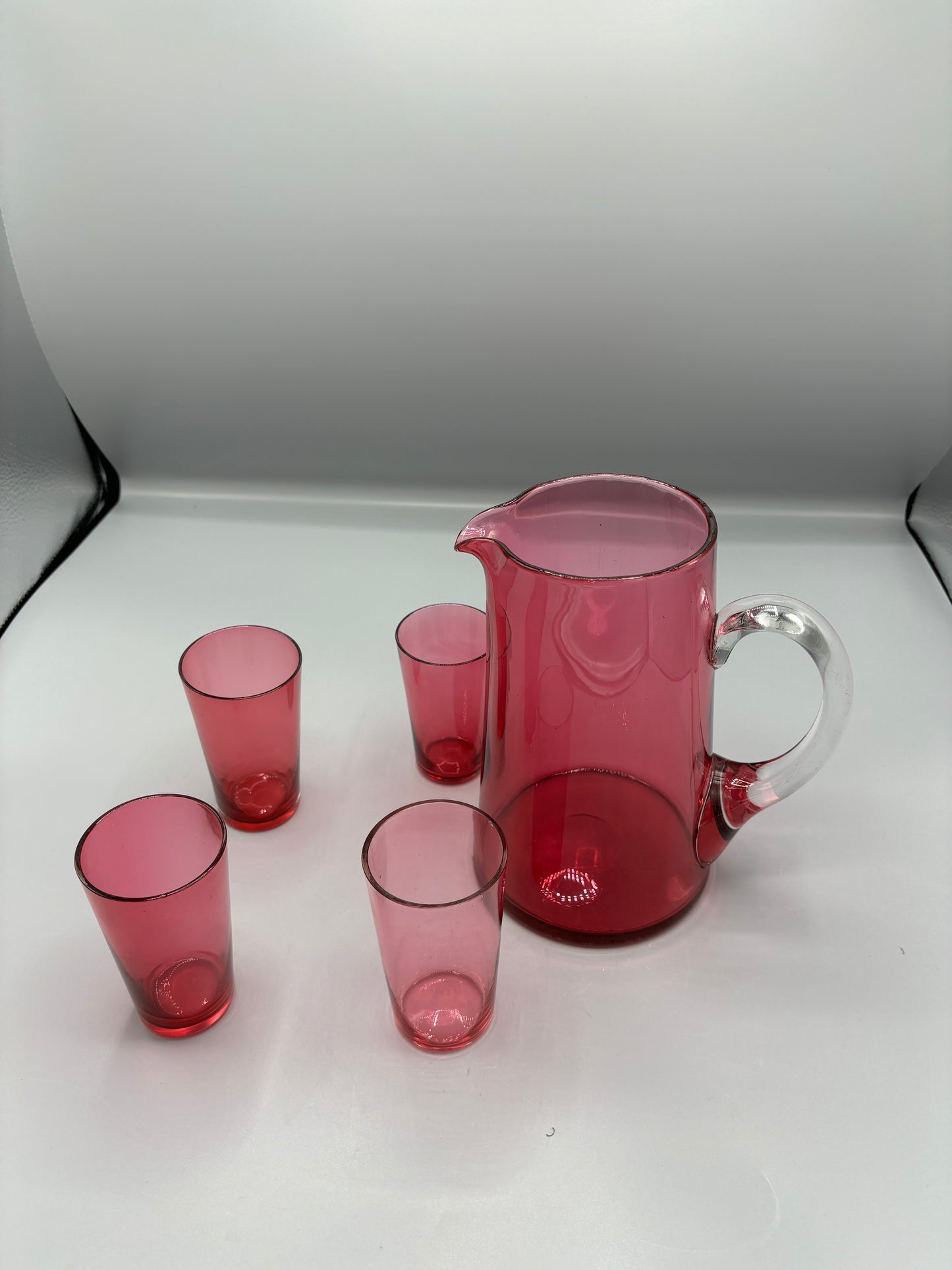 Vintage Cranberry glass pitcher with 4 handle cups