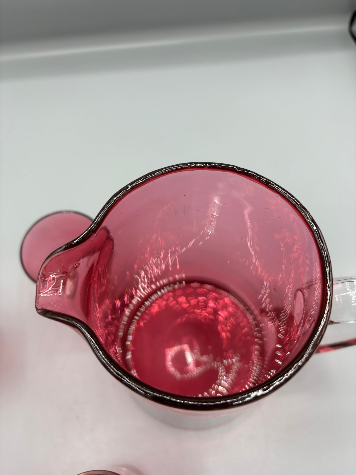 Vintage Cranberry glass pitcher with 4 handle cups