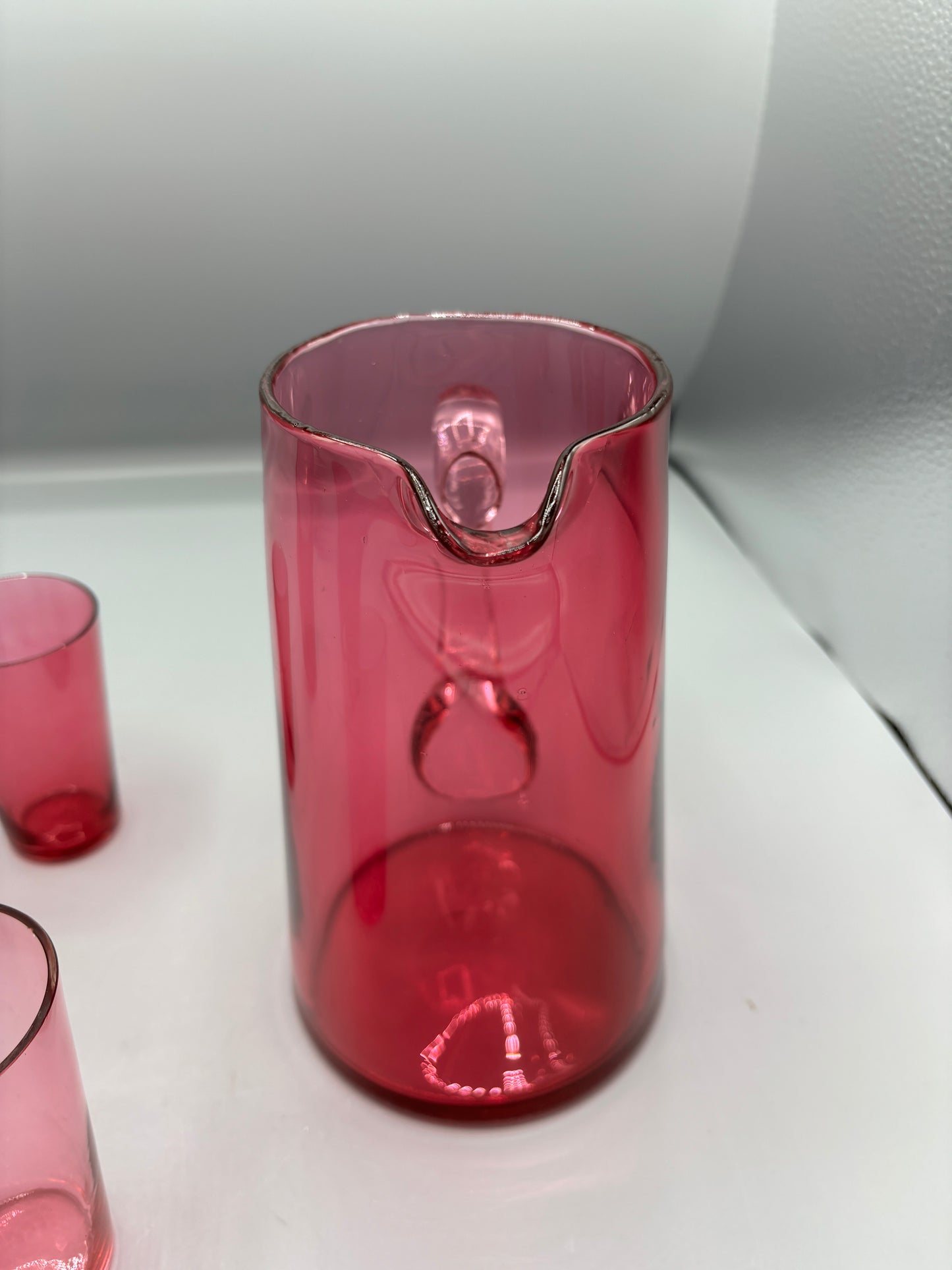 Vintage Cranberry glass pitcher with 4 handle cups