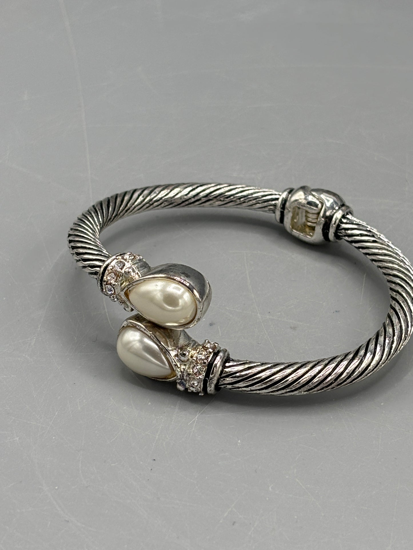 Silver tone cable style bypass bangle with pearl