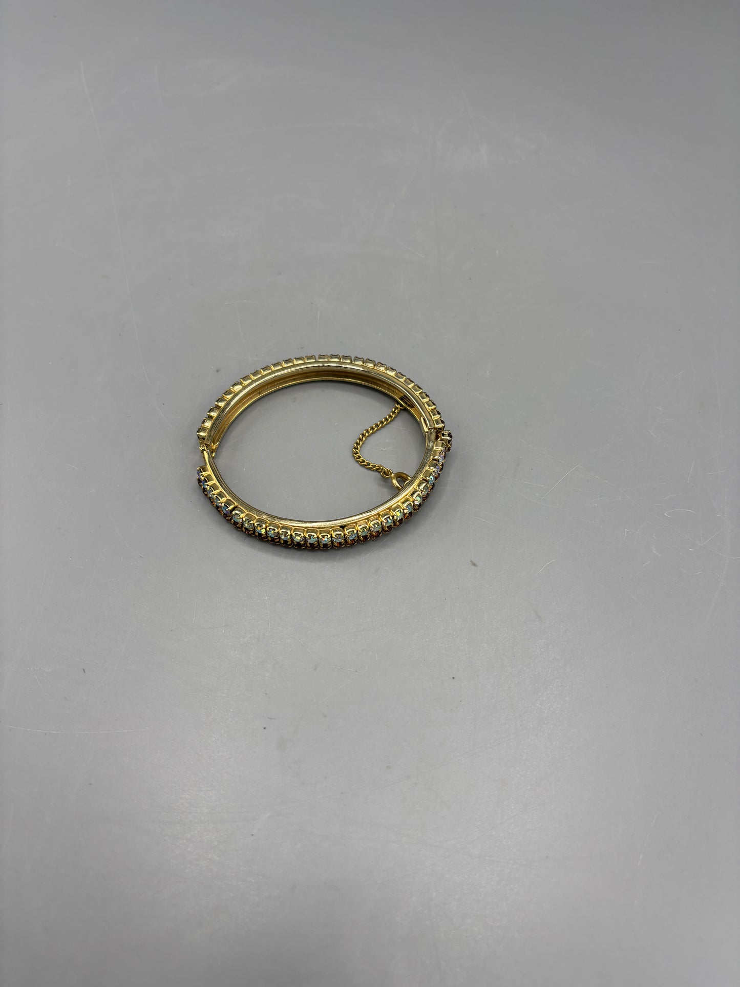 Gold tone bangle with 2 tone rhinestone