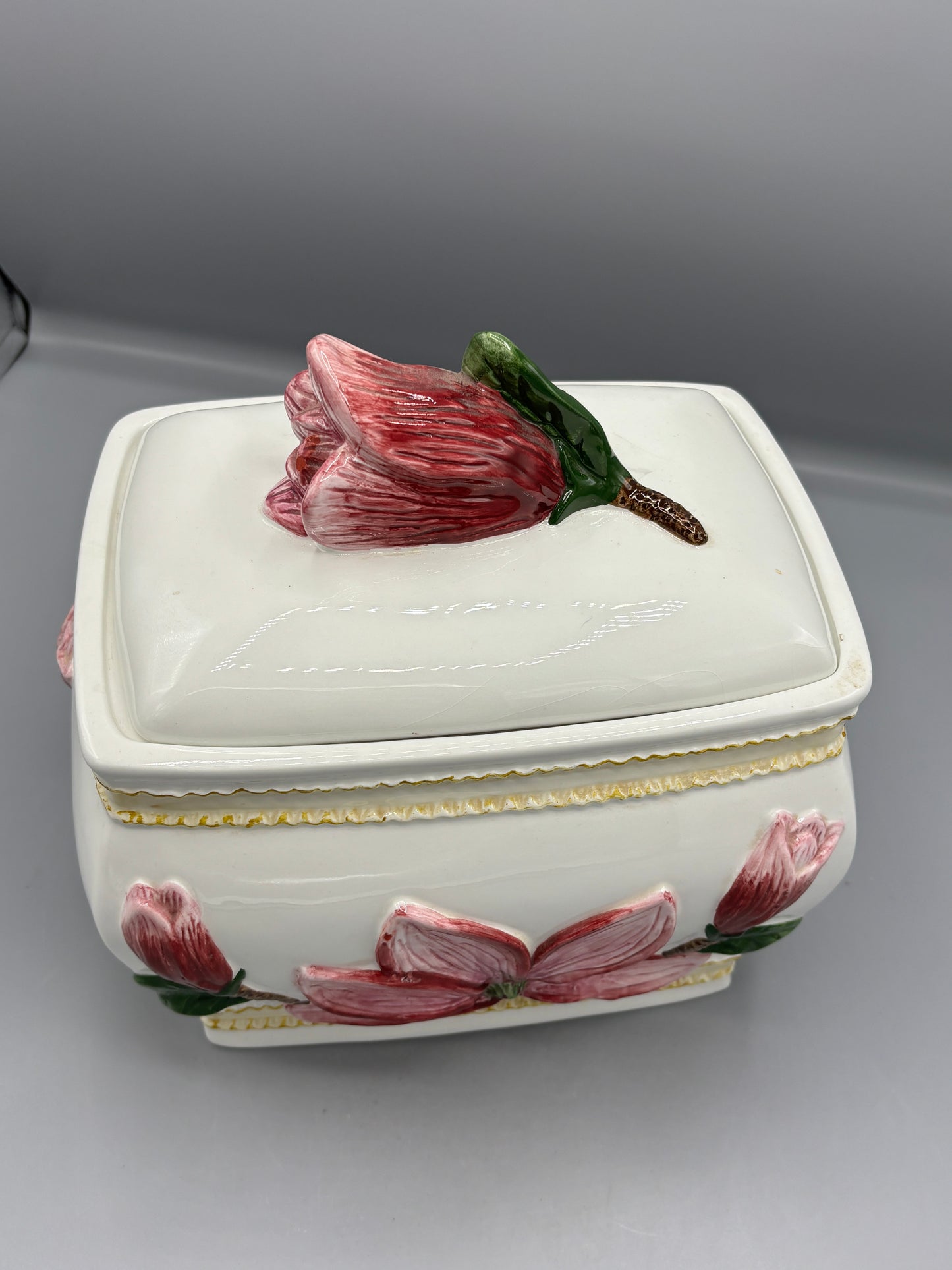 Ceramic lidded jar with applied pink magnolia blossom