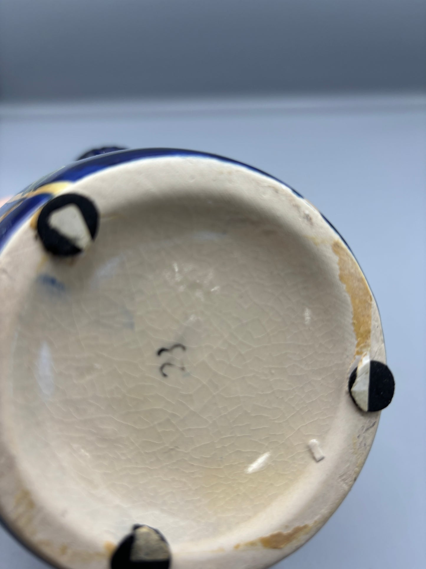 Blue glazed vase with yellow olive fruit