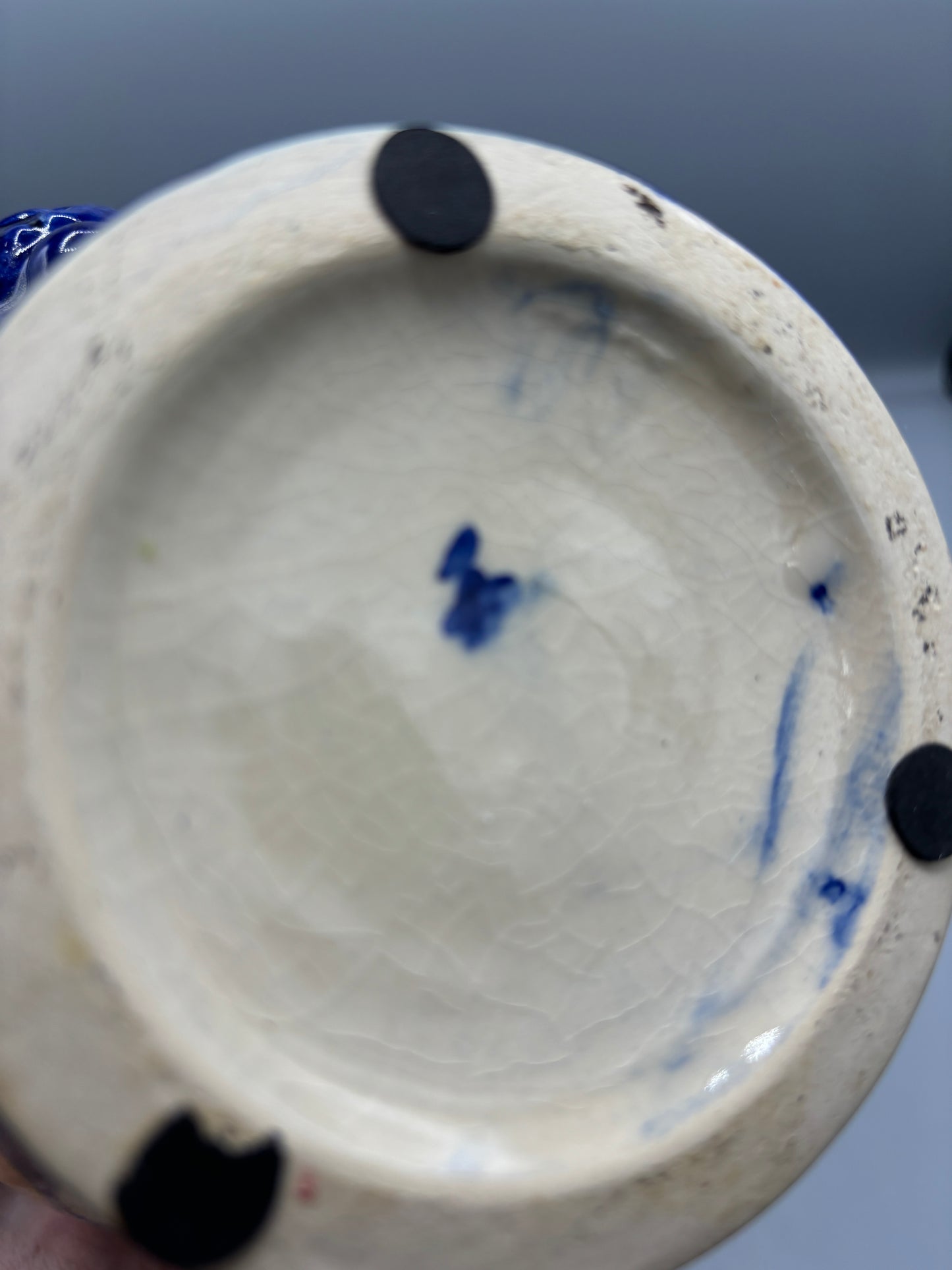 Blue glazed ceramic pitcher with yellow olive fruit
