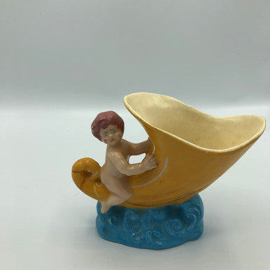 Baby riding a Cornucopia planter