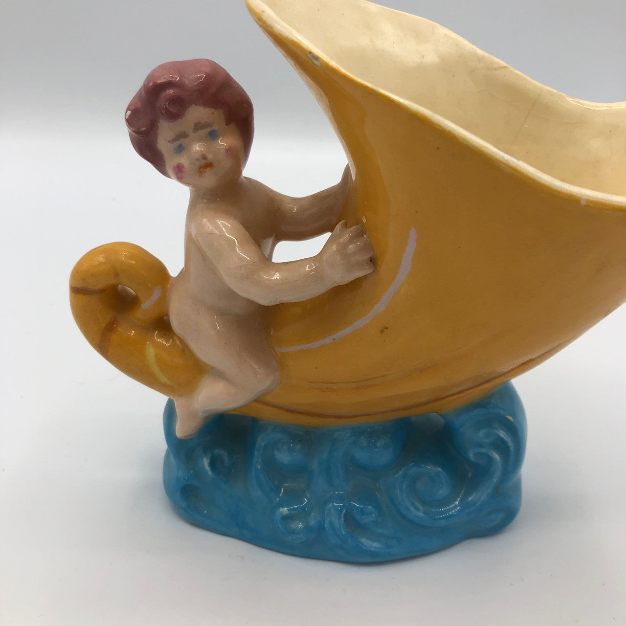 Baby riding a Cornucopia planter