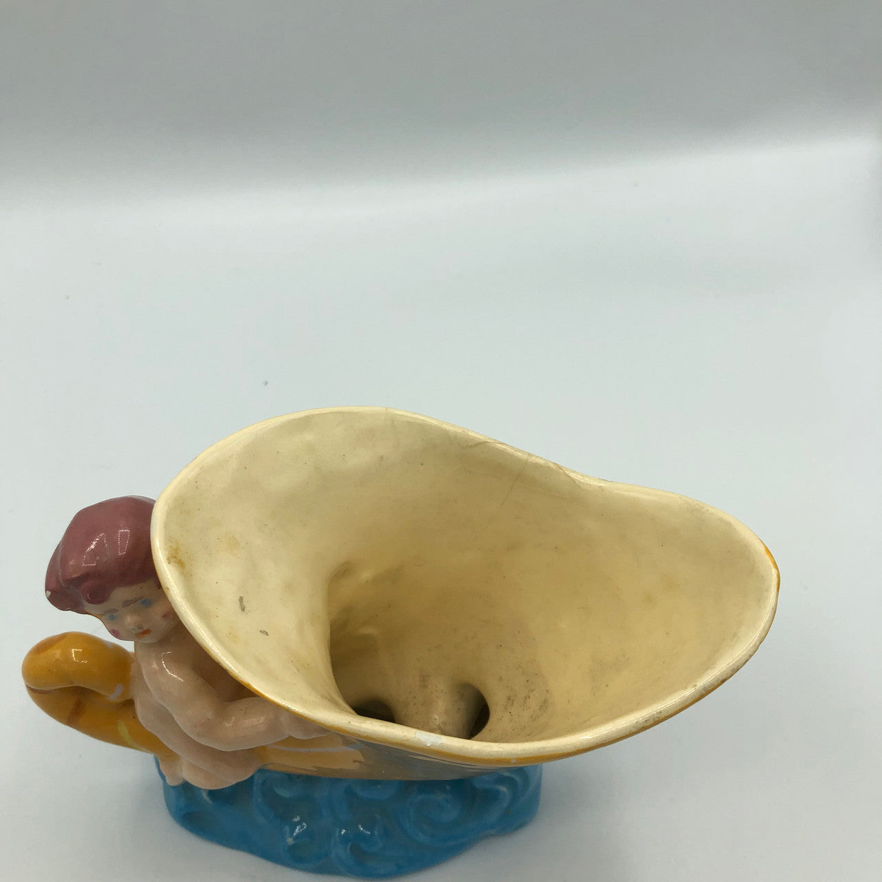 Baby riding a Cornucopia planter