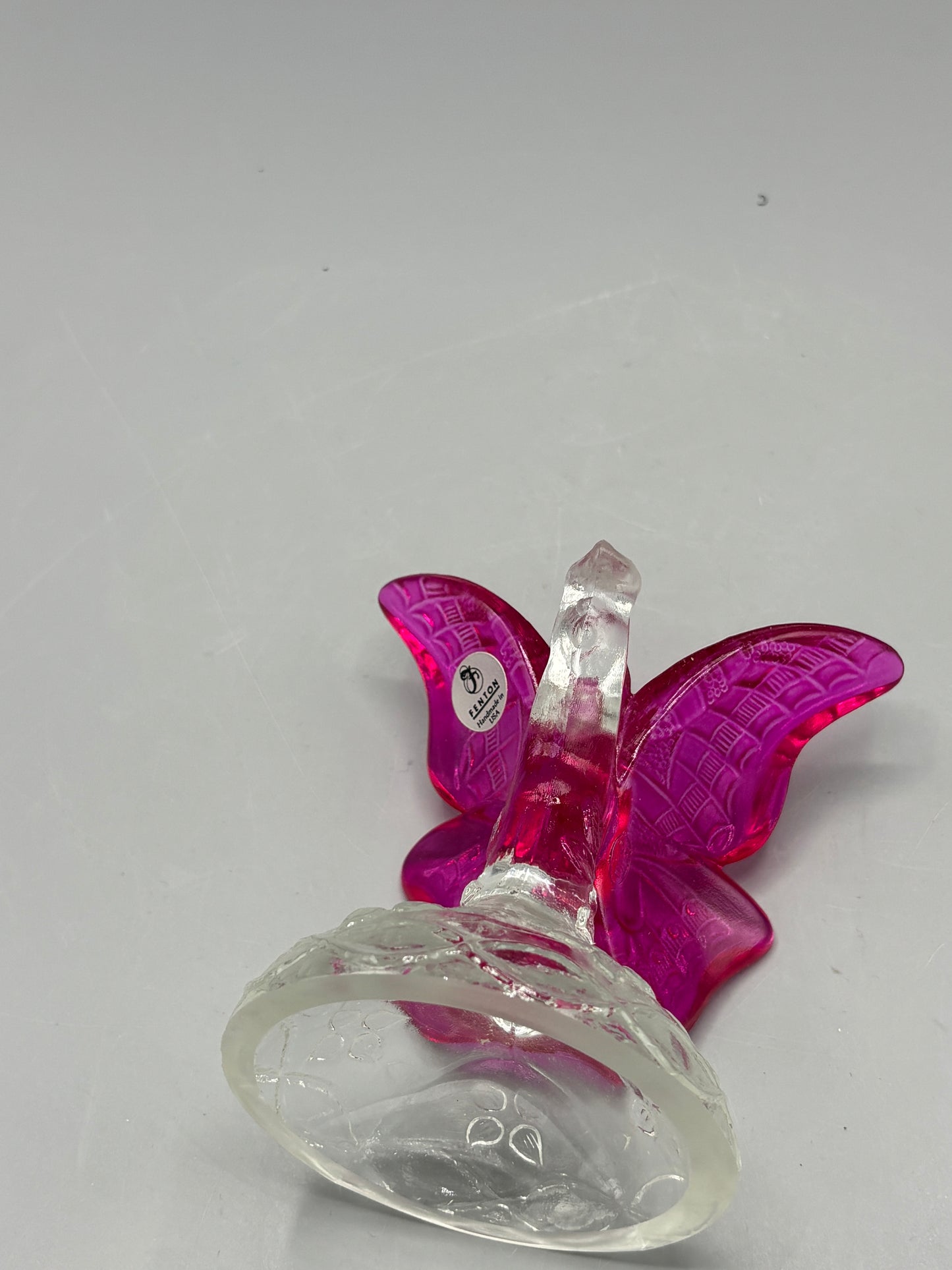 Vintage Fenton cranberry butterfly in a branch ring holder