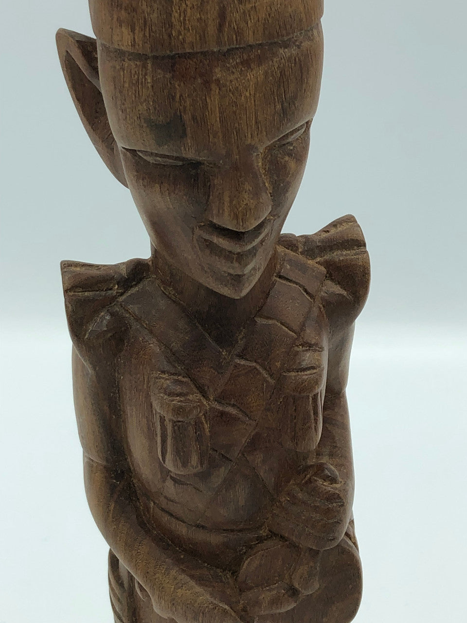 Wood hand carved man playing drum
