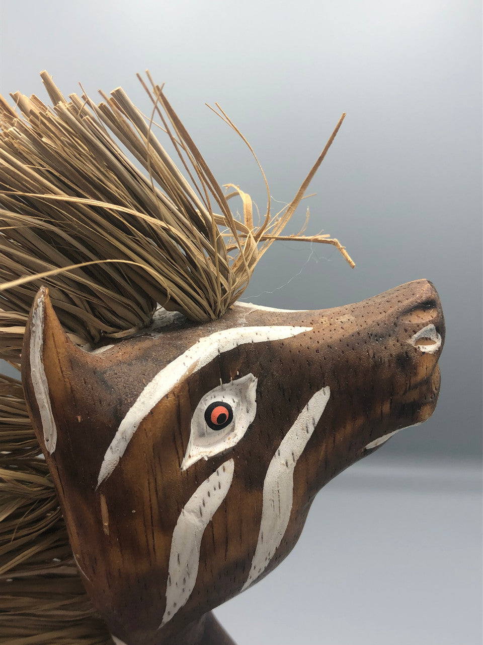 Wood giraffe with straw mane