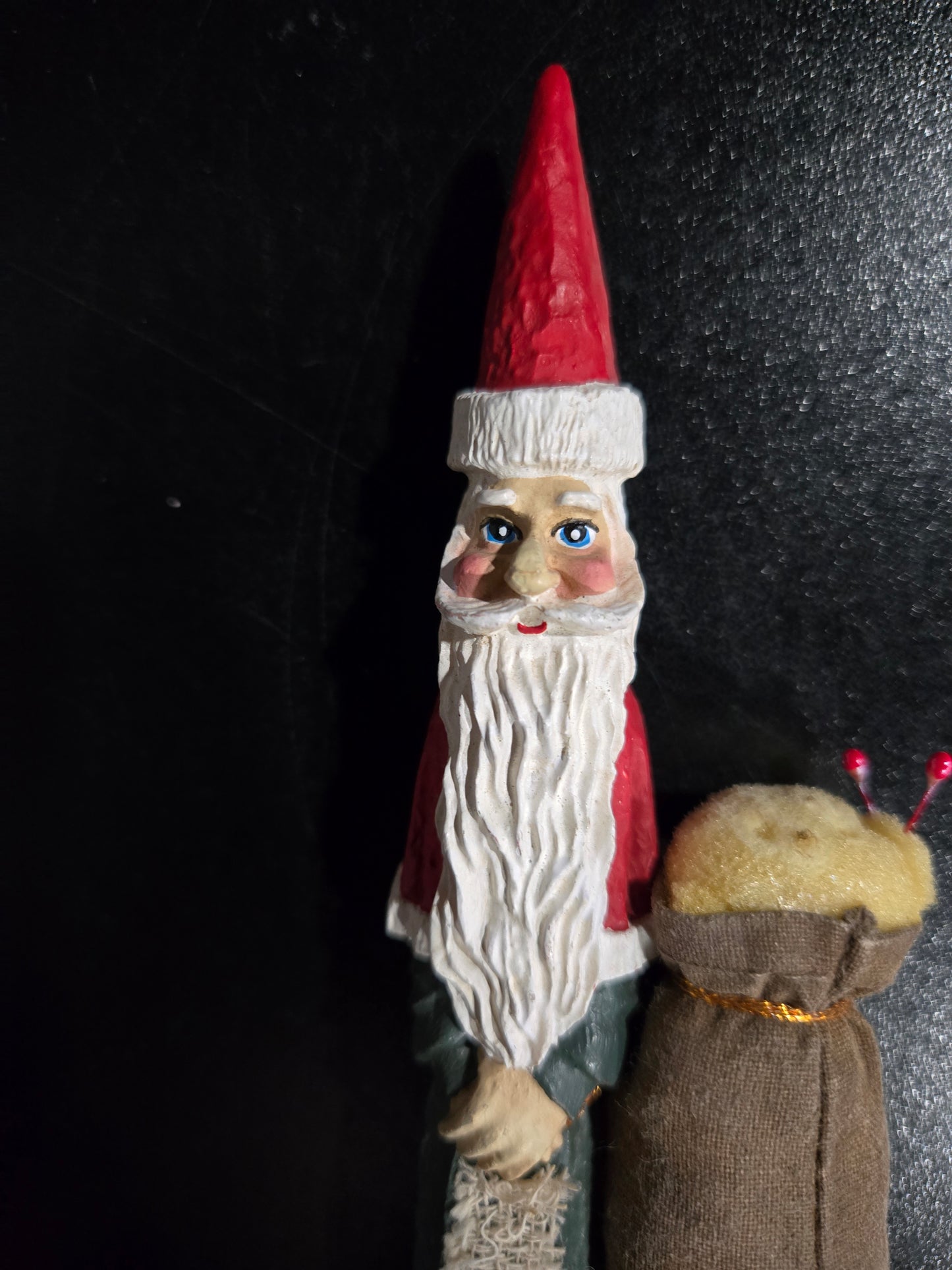 Resin Santa Claus holding big pin cushion