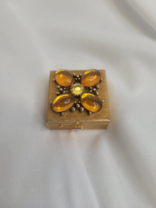 Small copper colored trinket box with gems