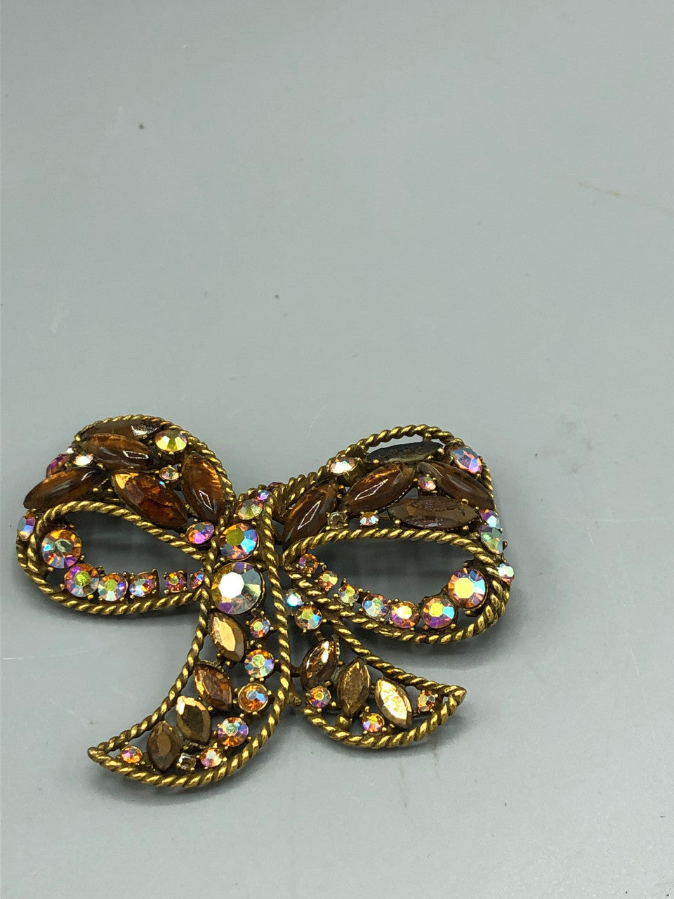 Multi colored stone bow brooch