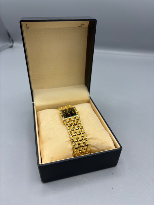 Vintage gold tone rectangular dress watch with black dial