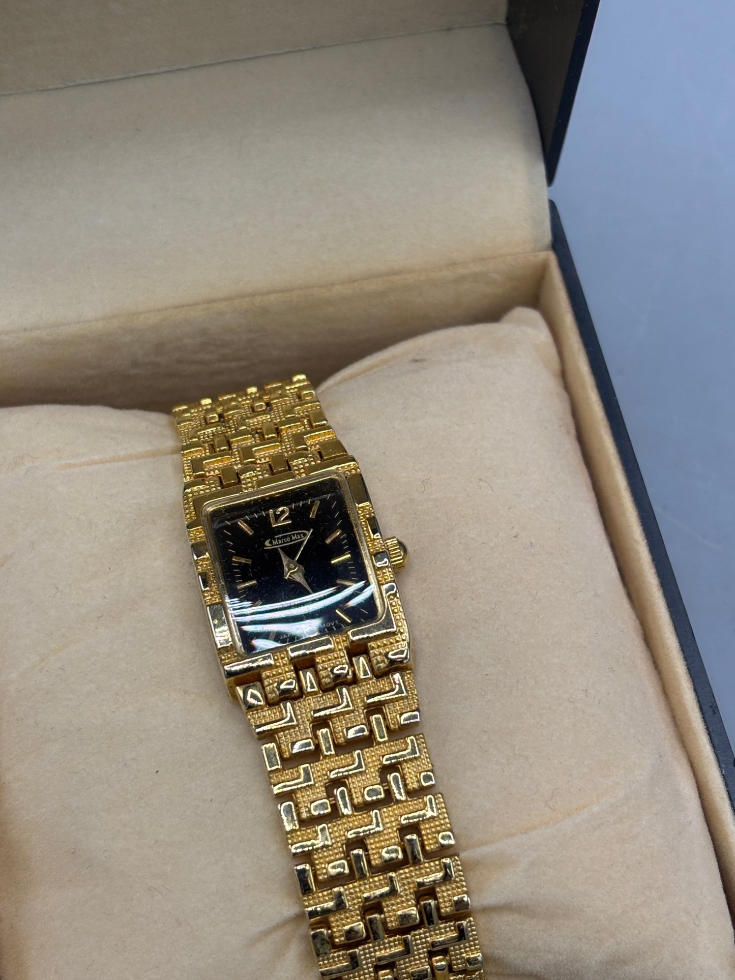 Vintage gold tone rectangular dress watch with black dial
