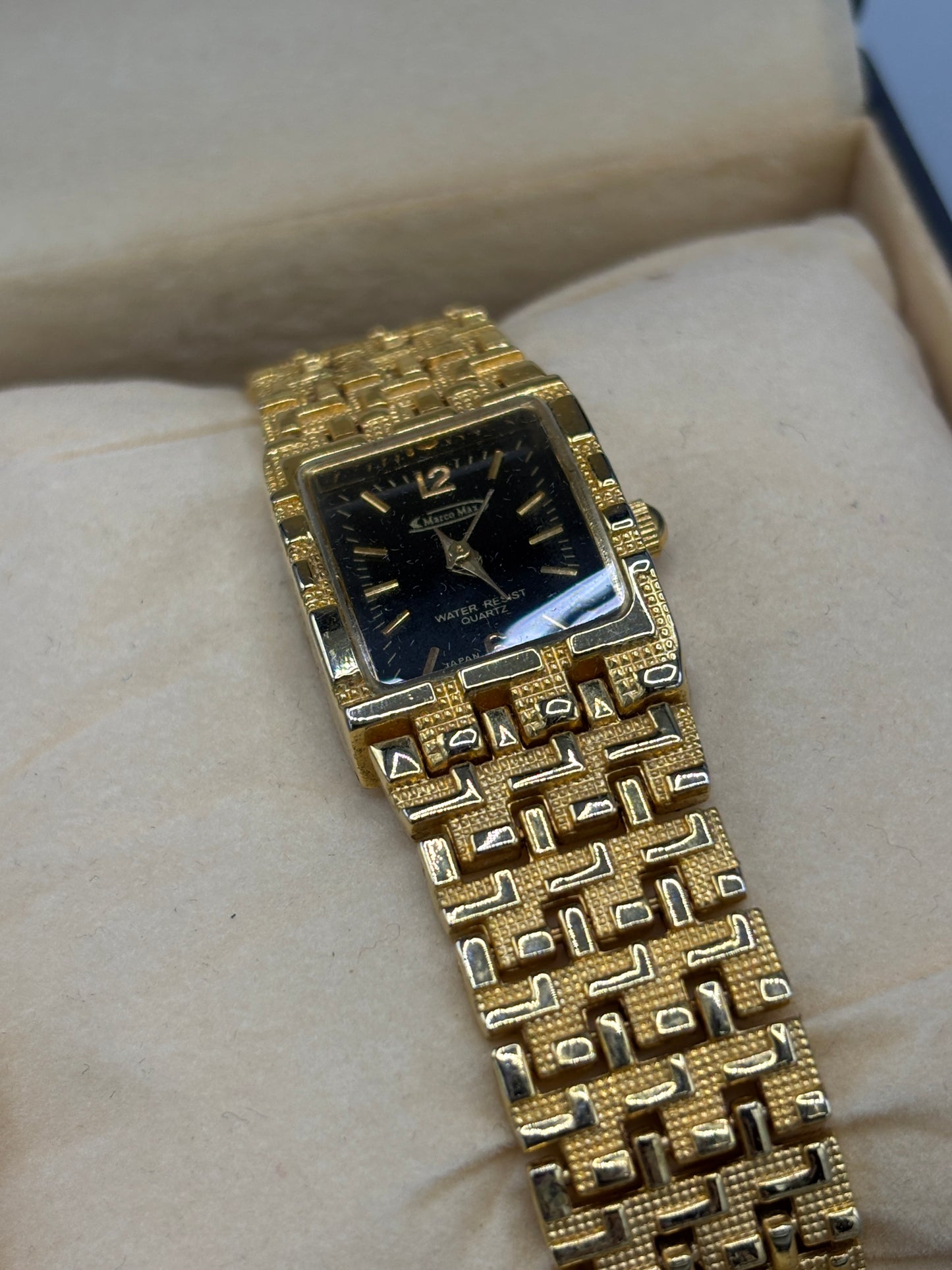 Vintage gold tone rectangular dress watch with black dial