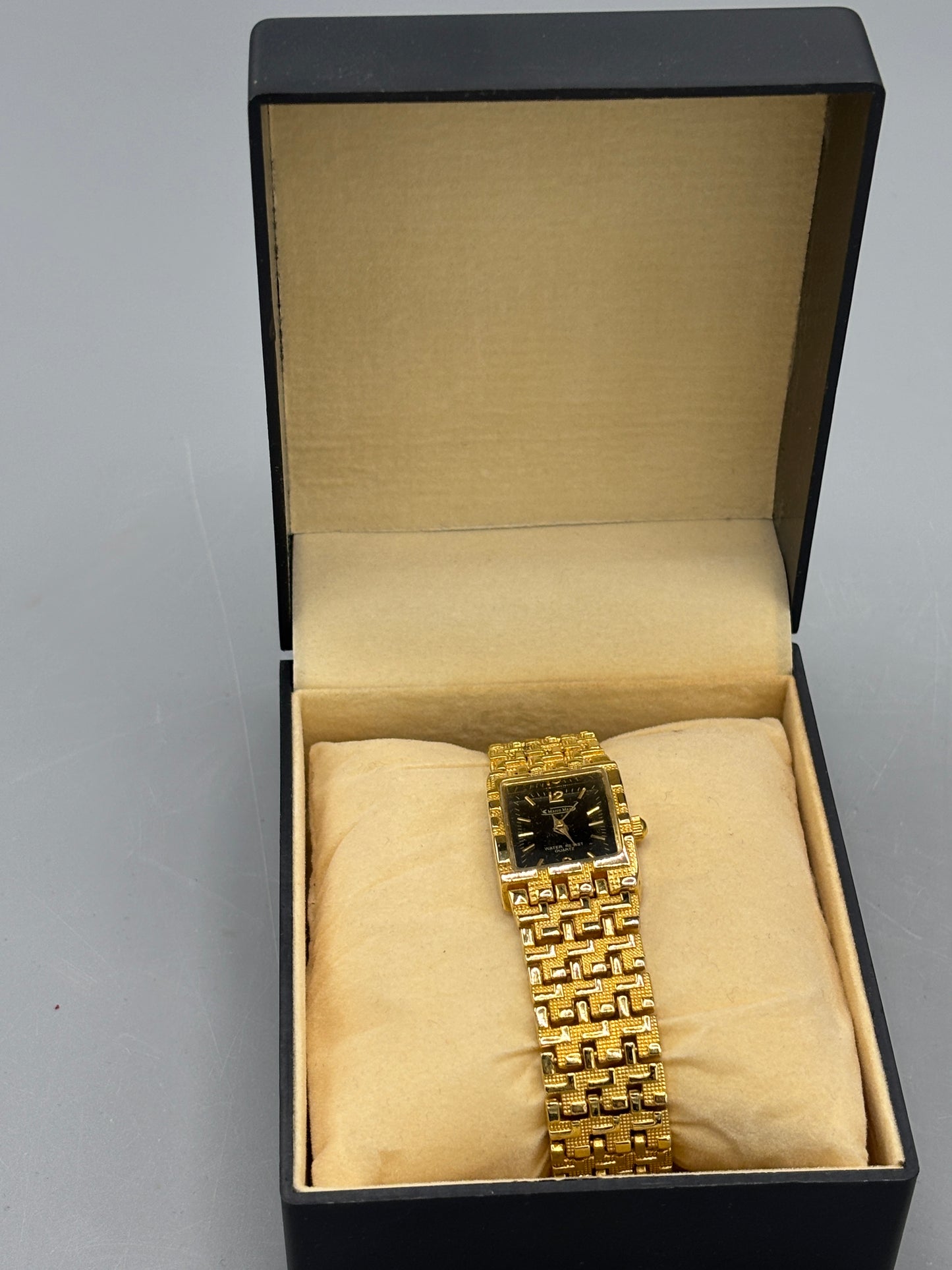 Vintage gold tone rectangular dress watch with black dial