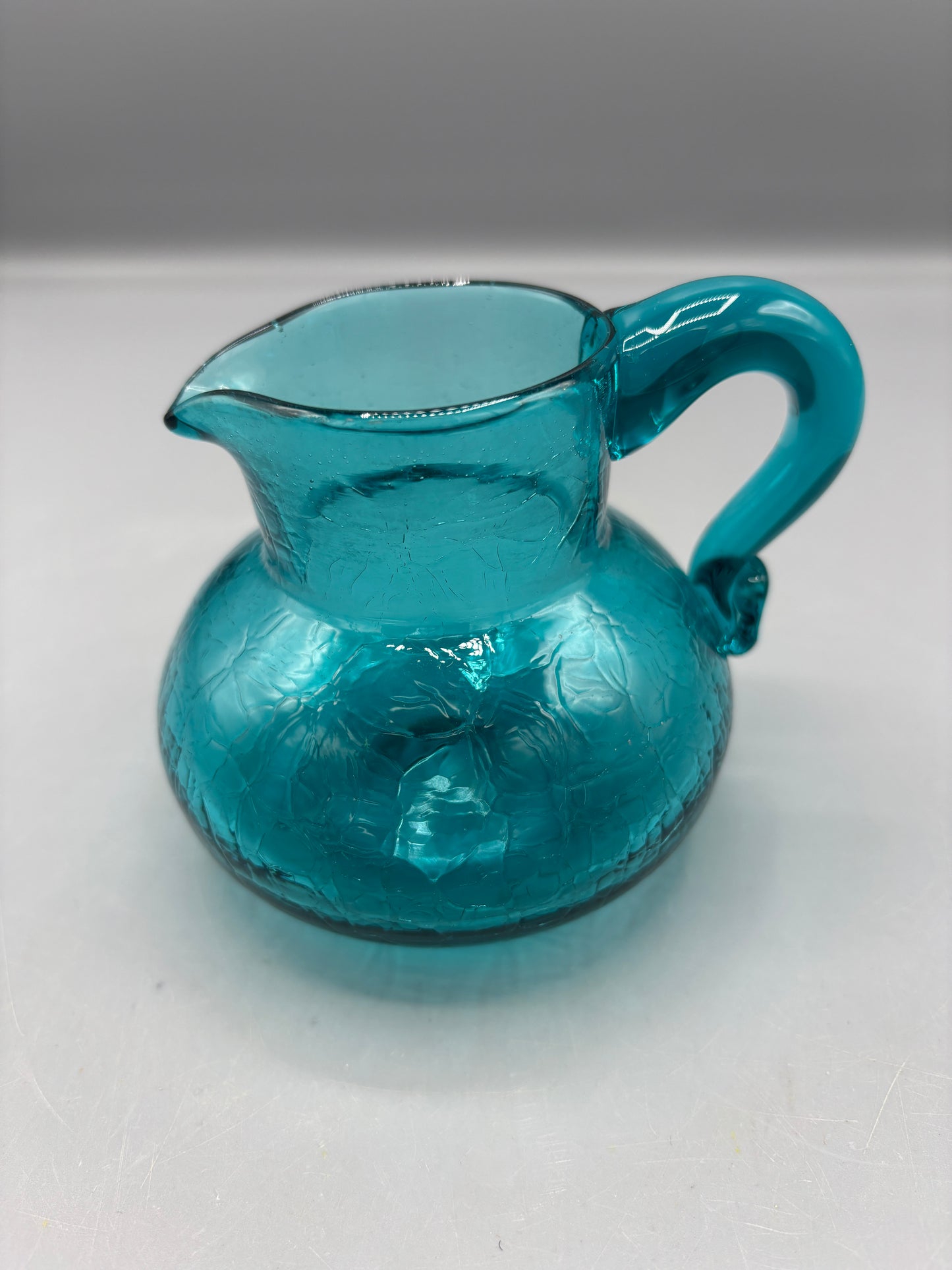 Teal hand blown textured glass pitcher