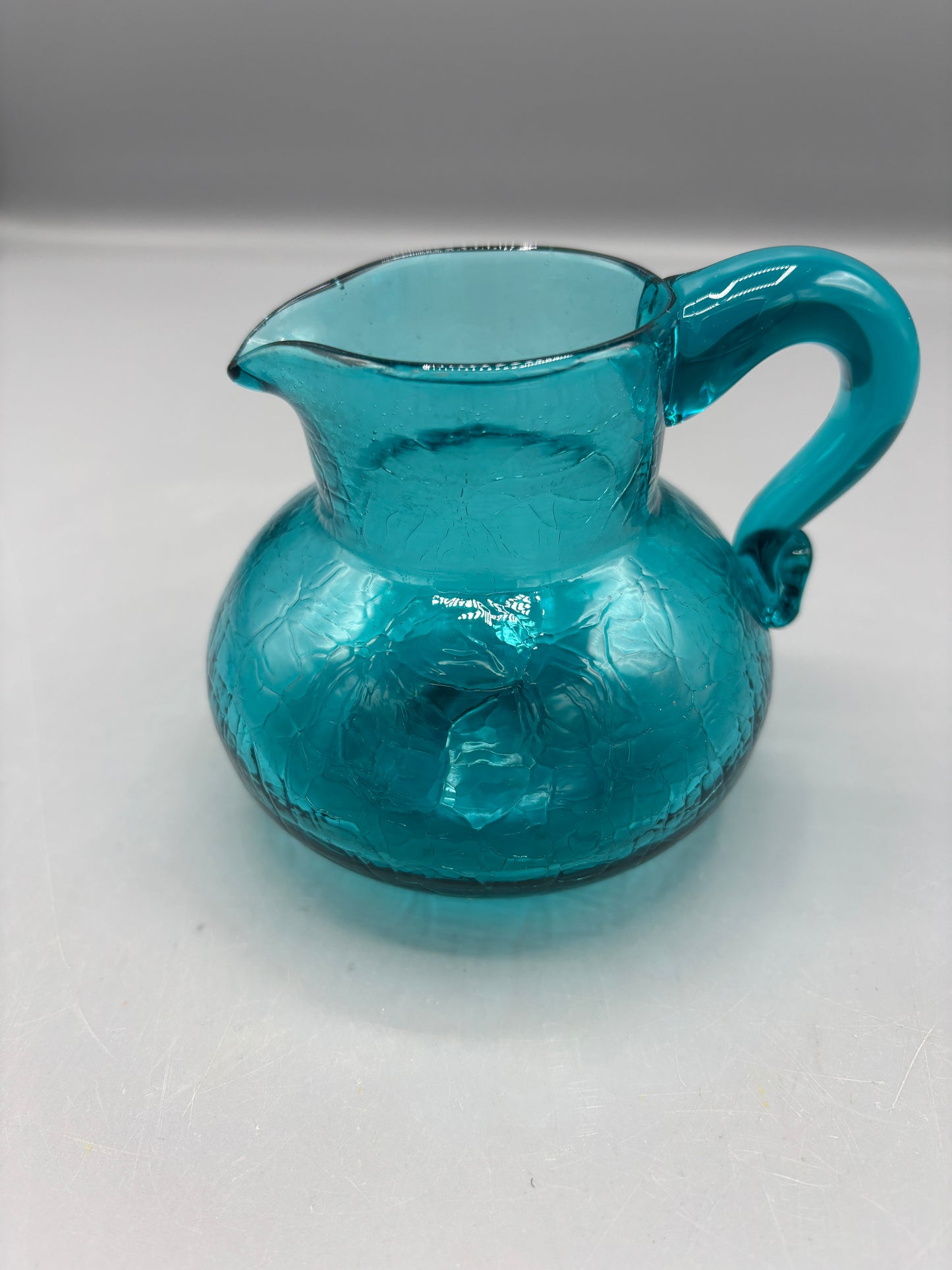 Teal hand blown textured glass pitcher