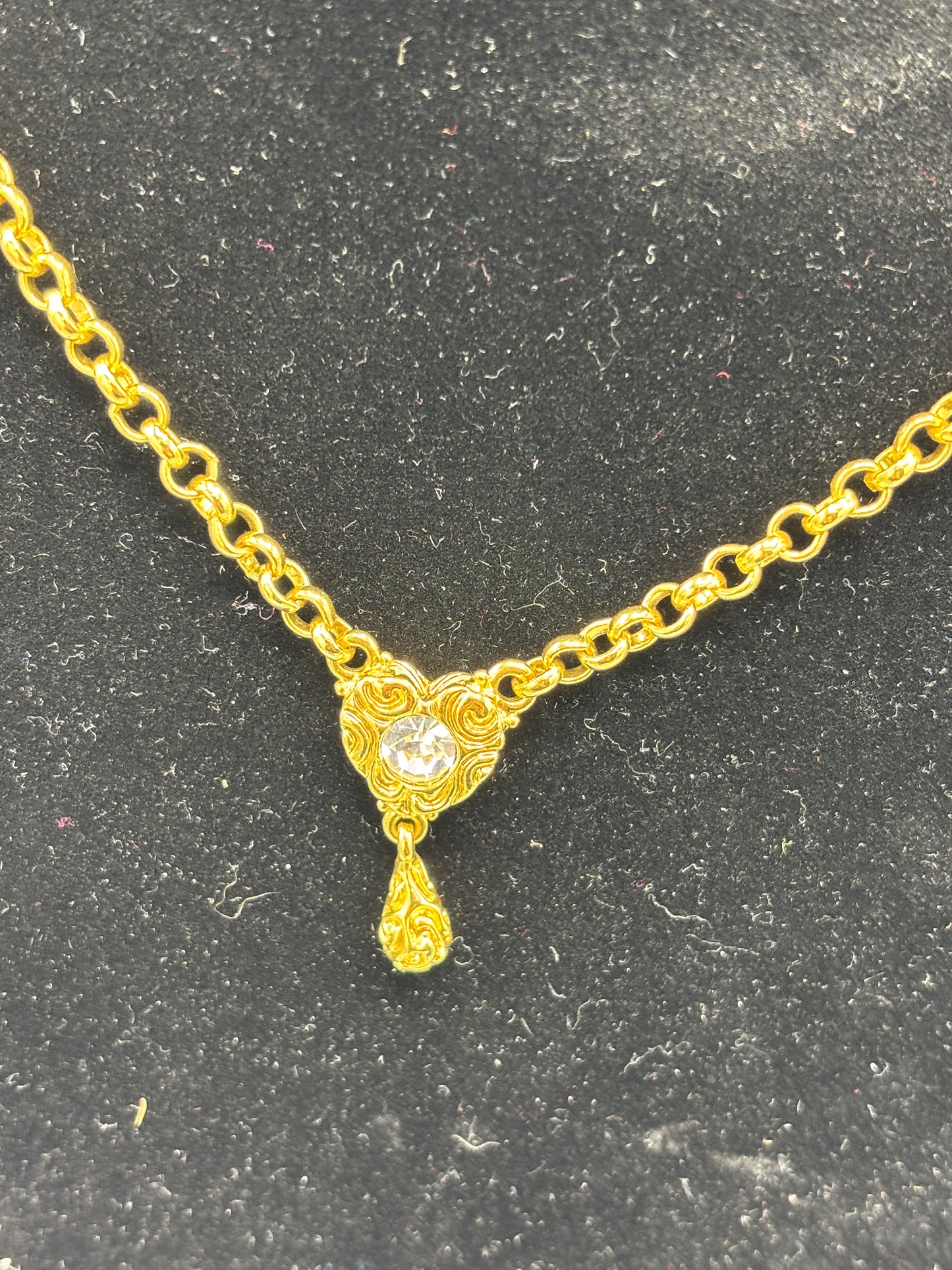 Gold tone necklace with heart crystal pendant