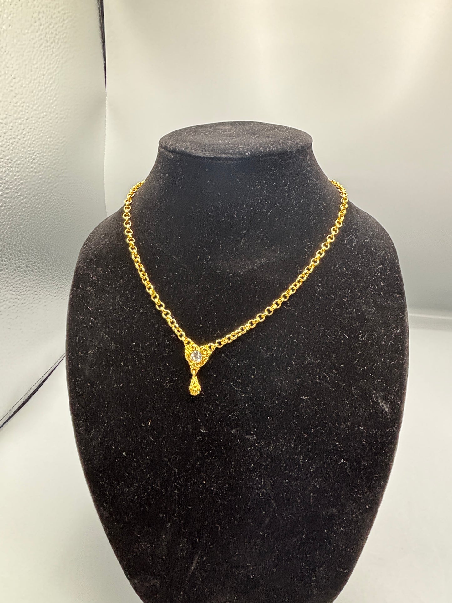 Gold tone necklace with heart crystal pendant