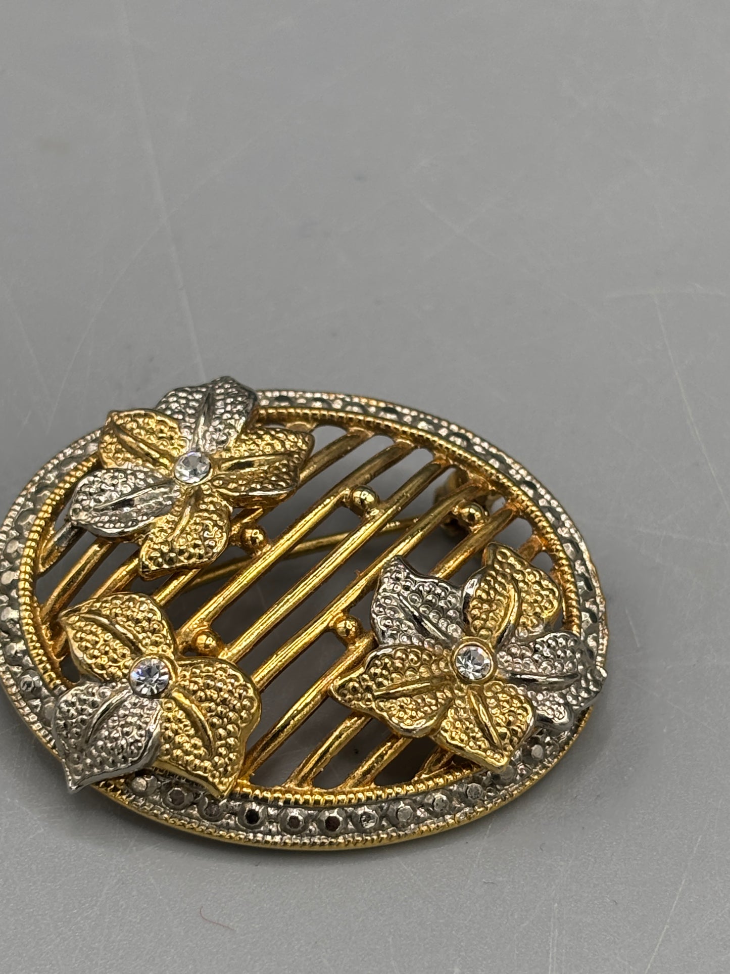 Oval gold tone brooch