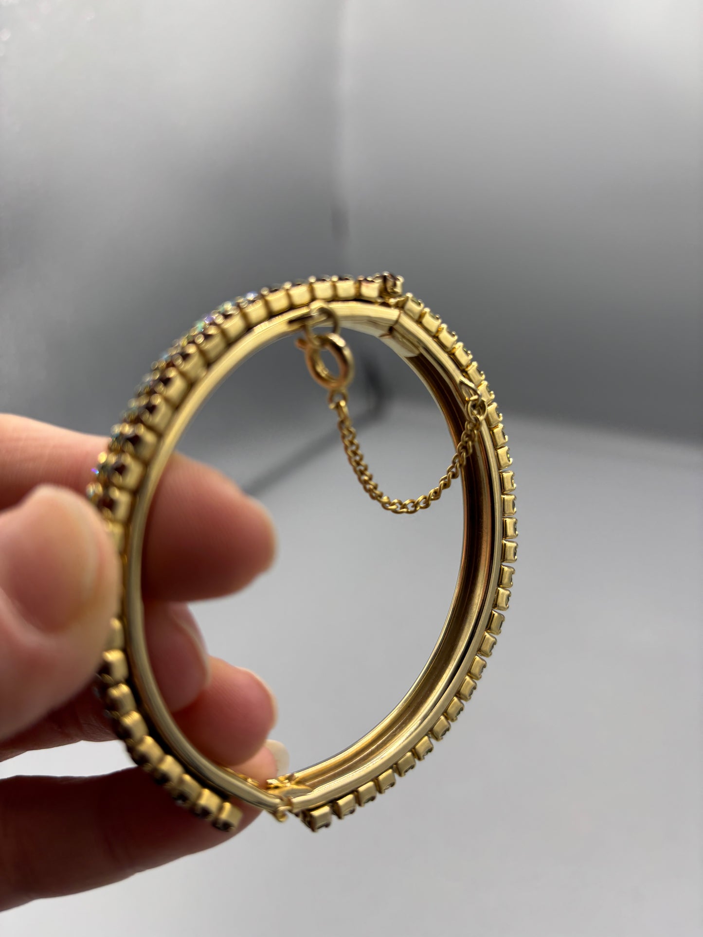 Gold tone bangle with 2 tone rhinestone