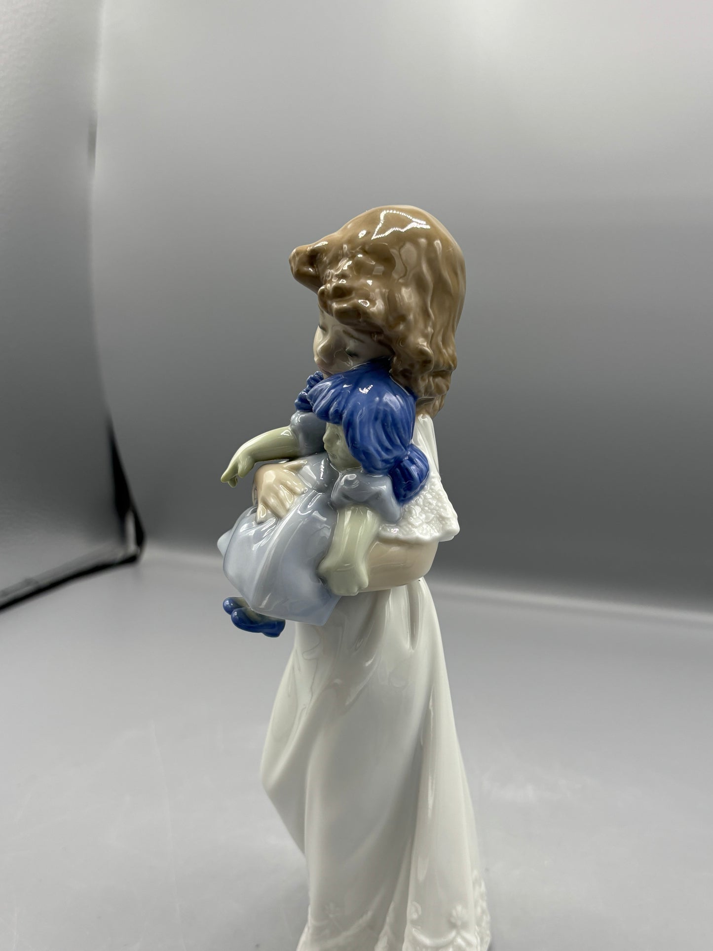 Nao by Lladro girl with doll "We're sleepy"