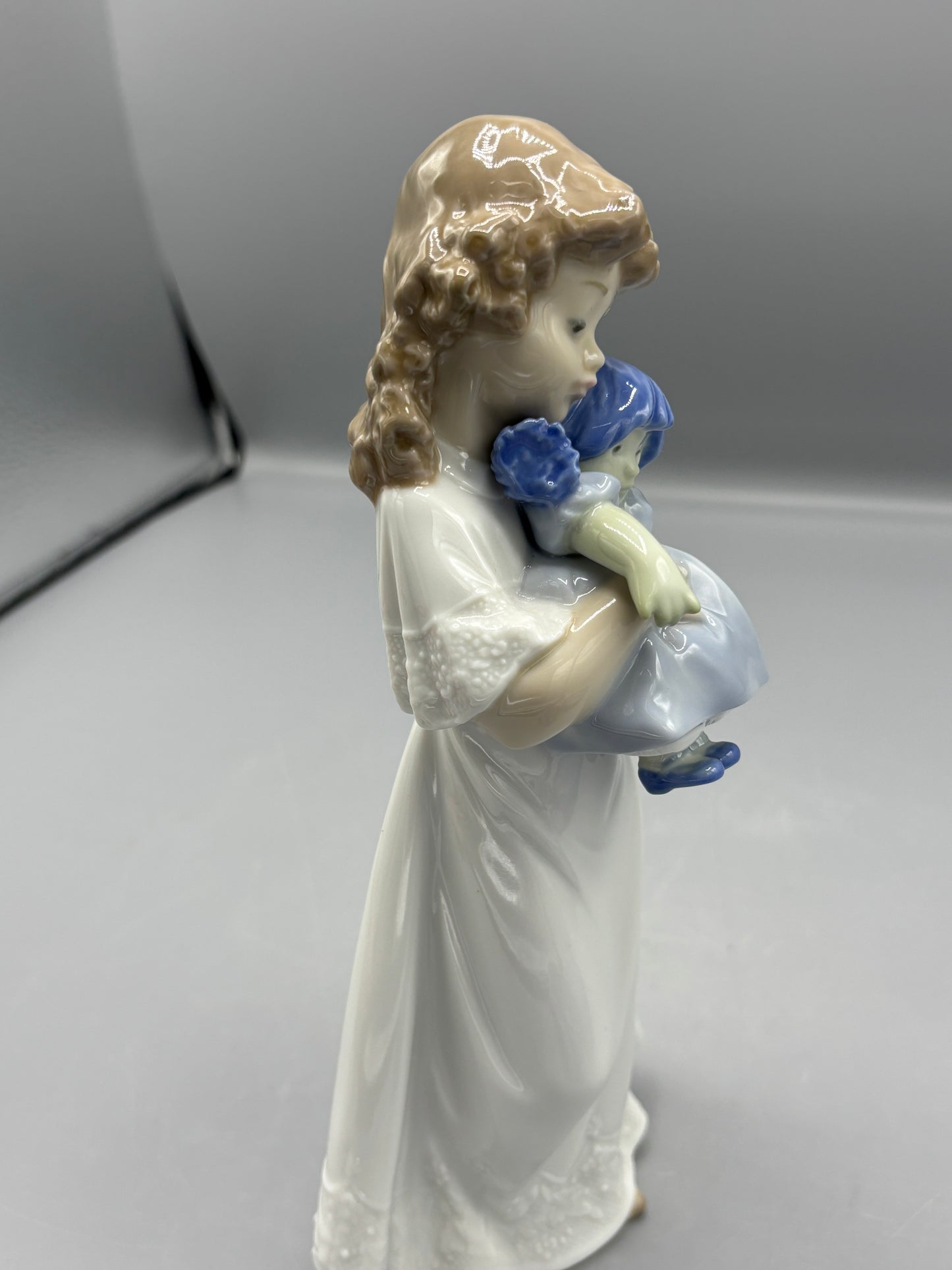 Nao by Lladro girl with doll "We're sleepy"