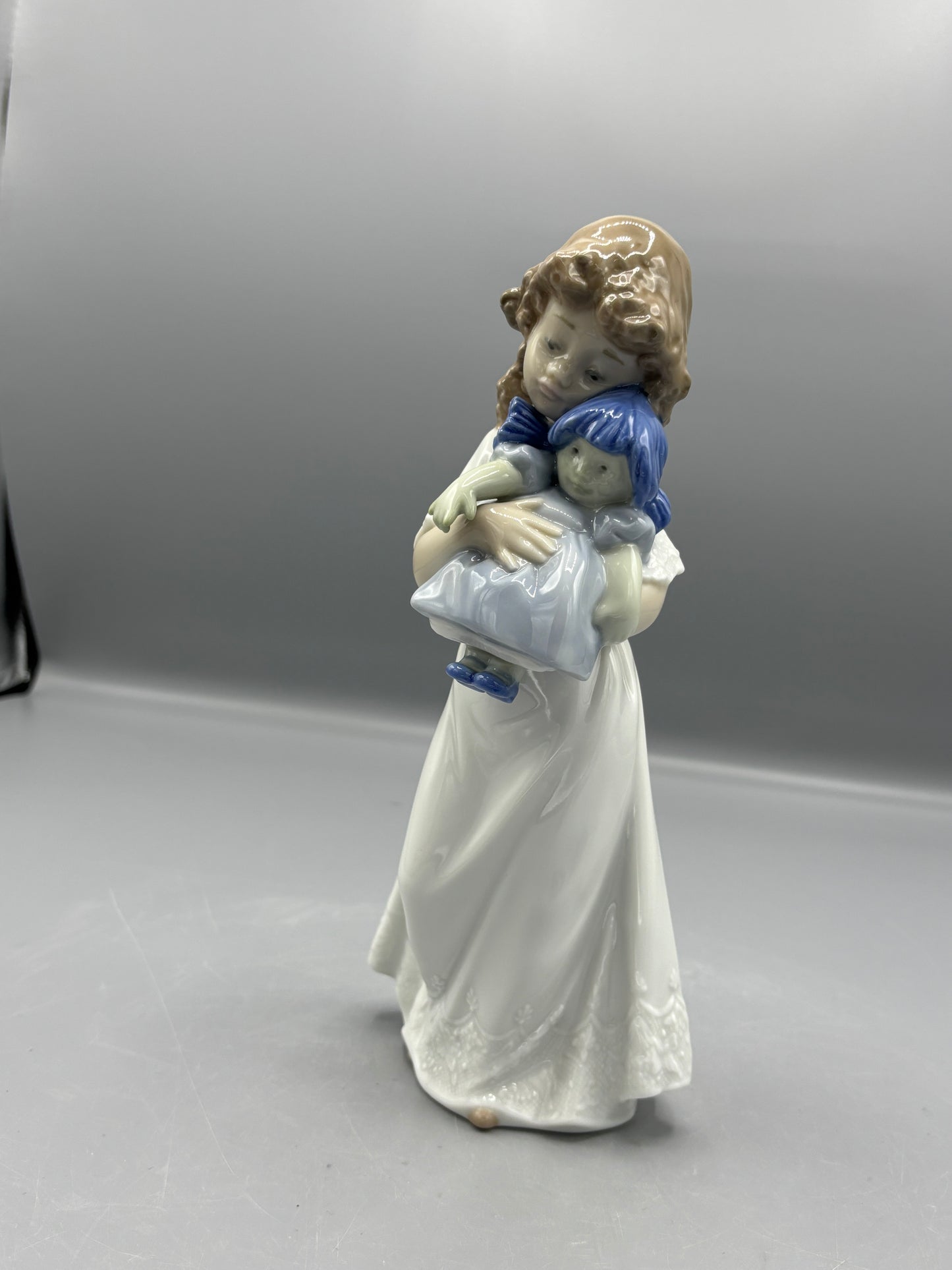 Nao by Lladro girl with doll "We're sleepy"