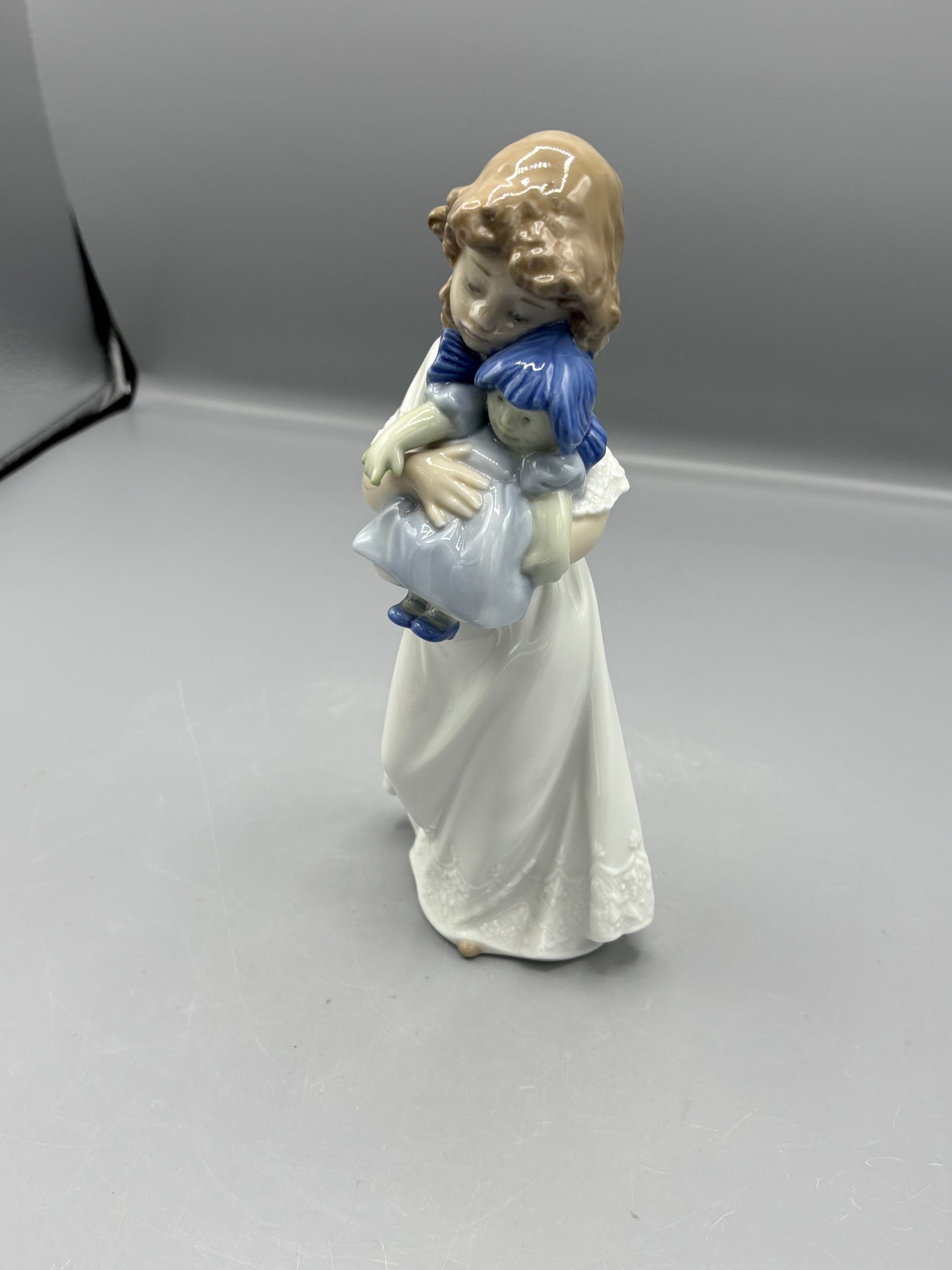 Nao by Lladro girl with doll "We're sleepy"