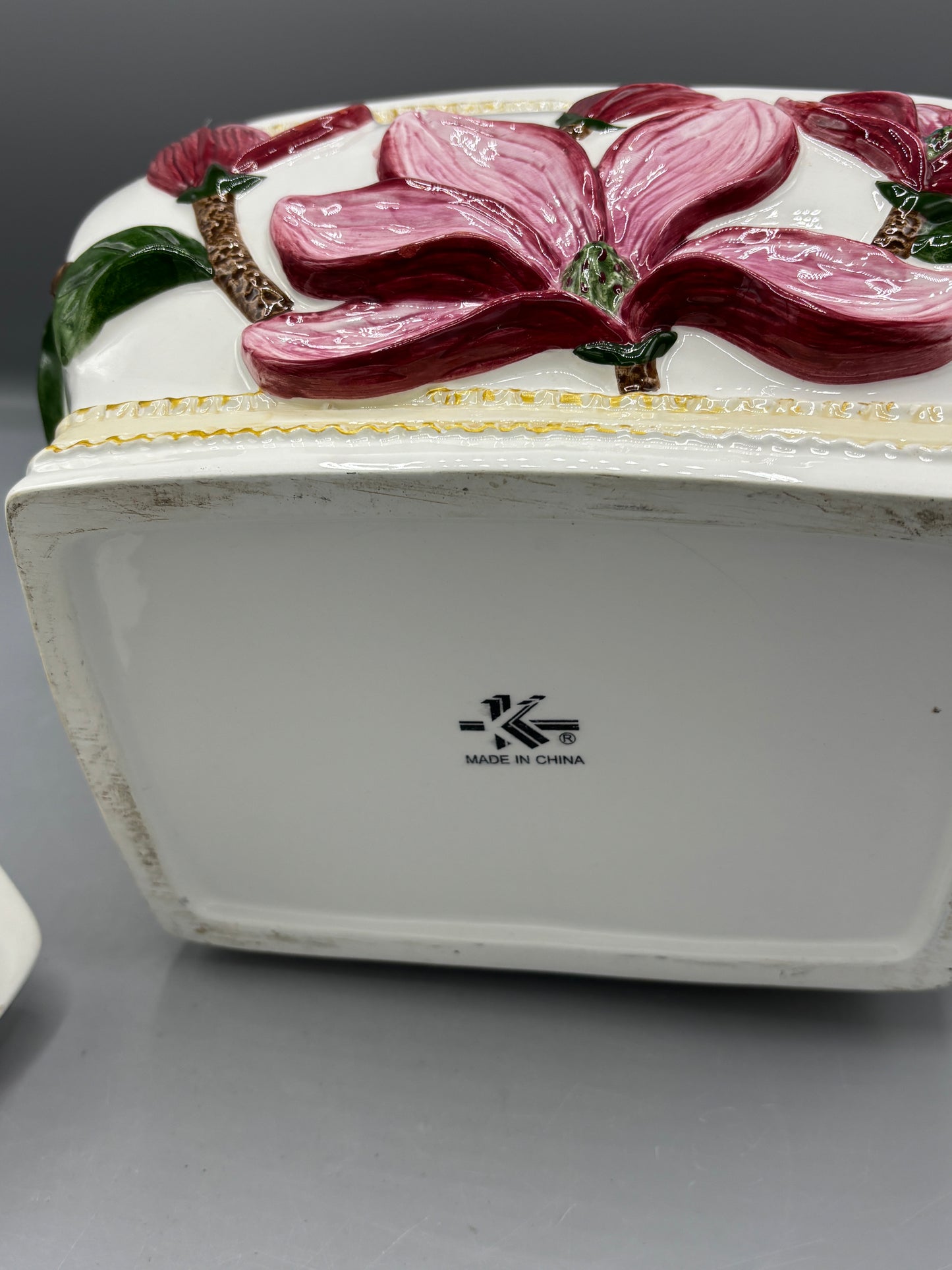 Ceramic lidded jar with applied pink magnolia blossom