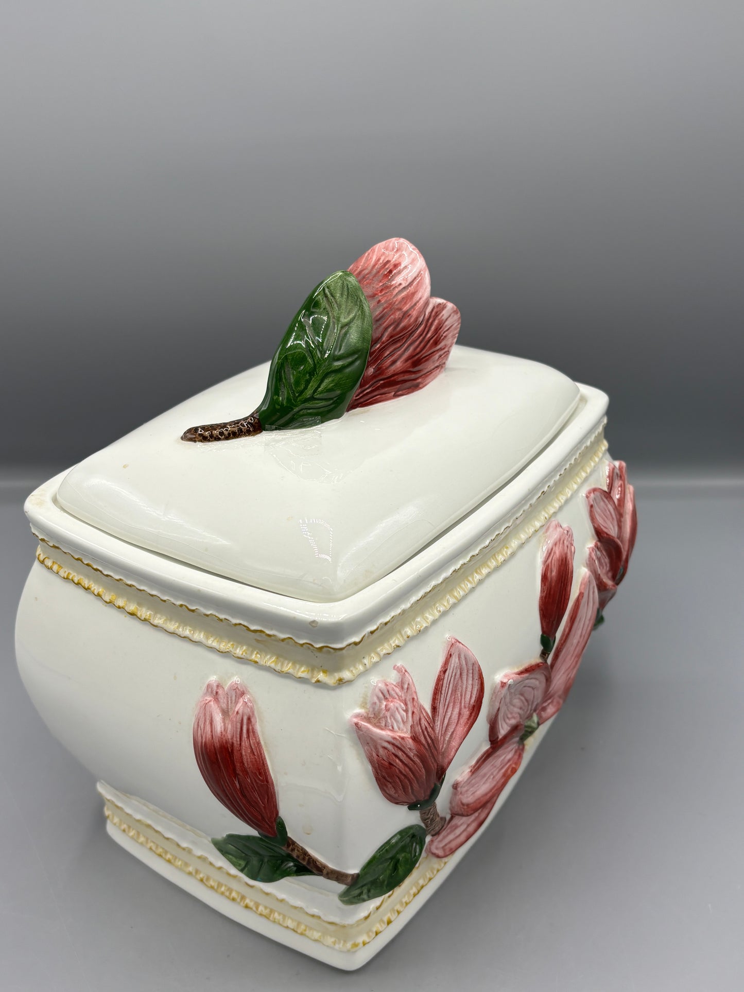 Ceramic lidded jar with applied pink magnolia blossom