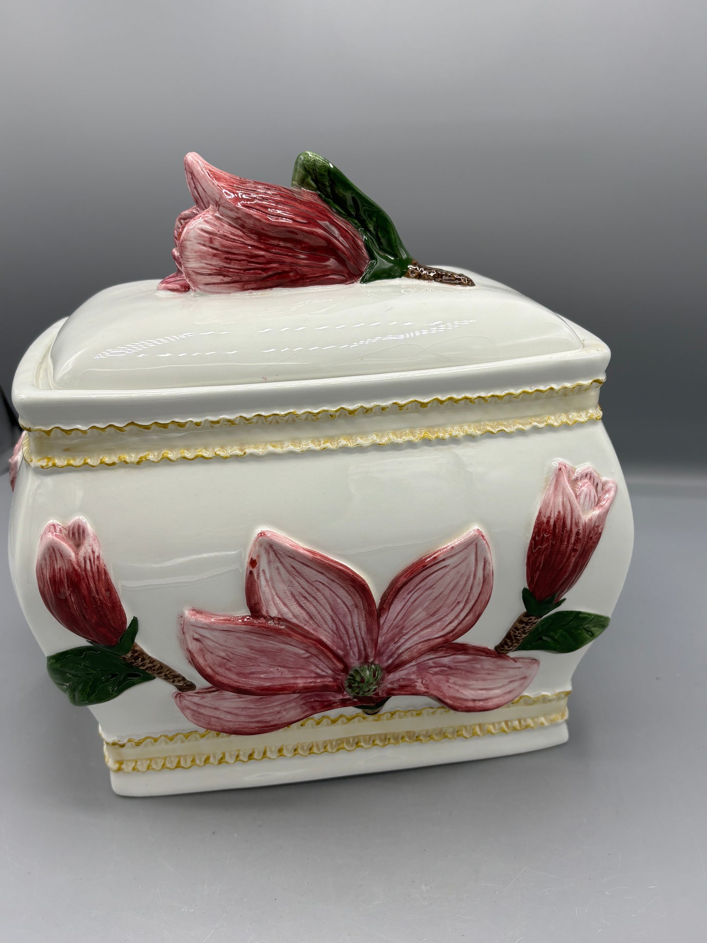 Ceramic lidded jar with applied pink magnolia blossom