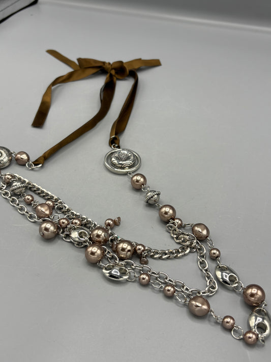 Silver beads with brown ribbon