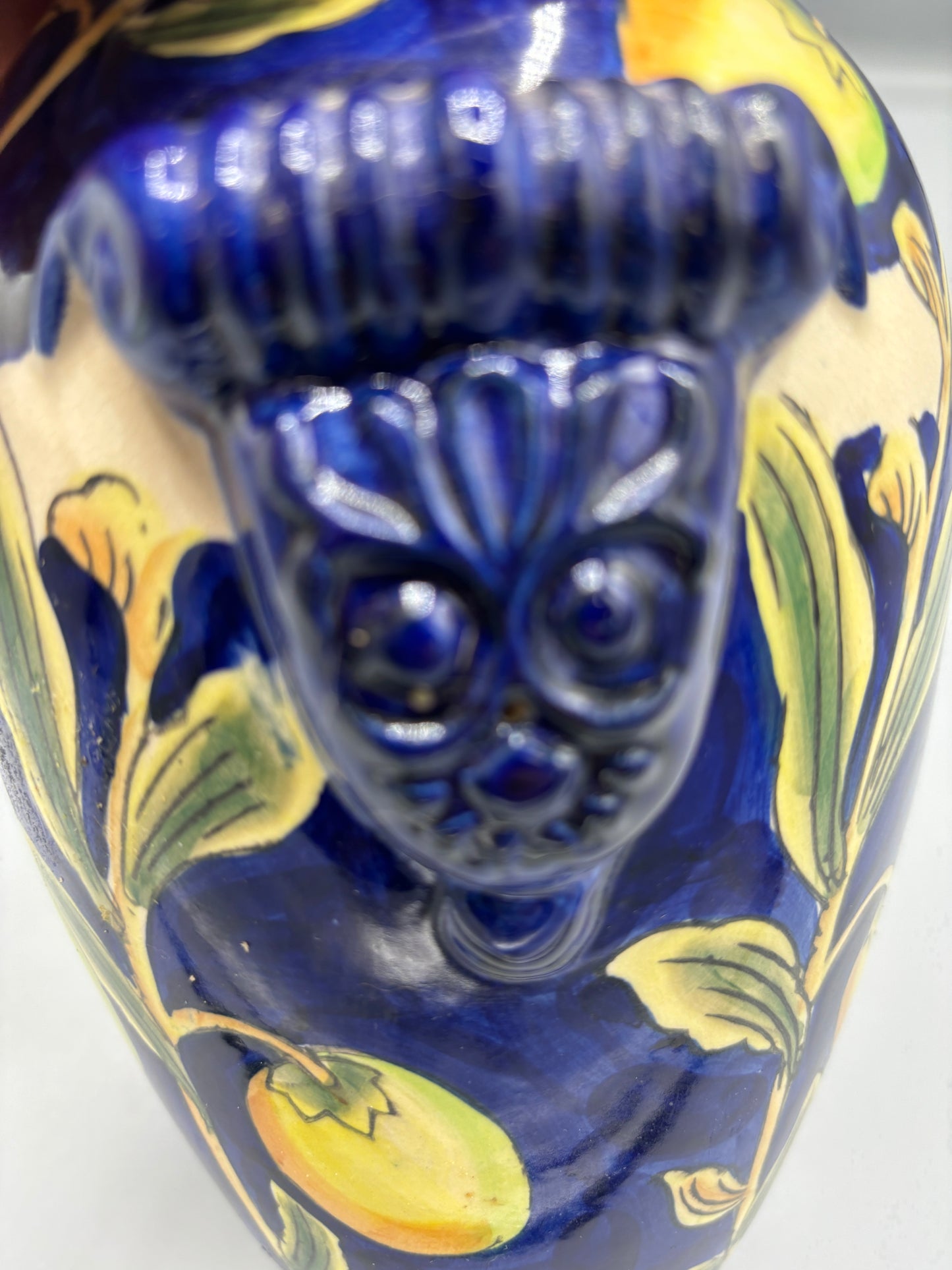 Blue glazed vase with yellow olive fruit