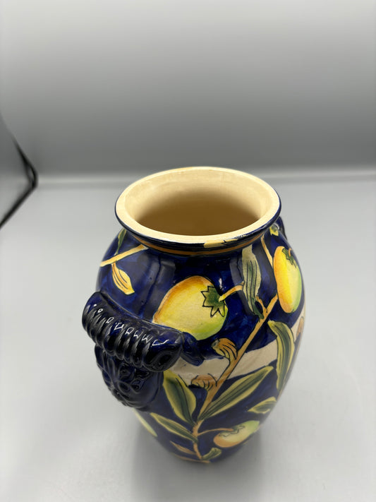 Blue glazed vase with yellow olive fruit