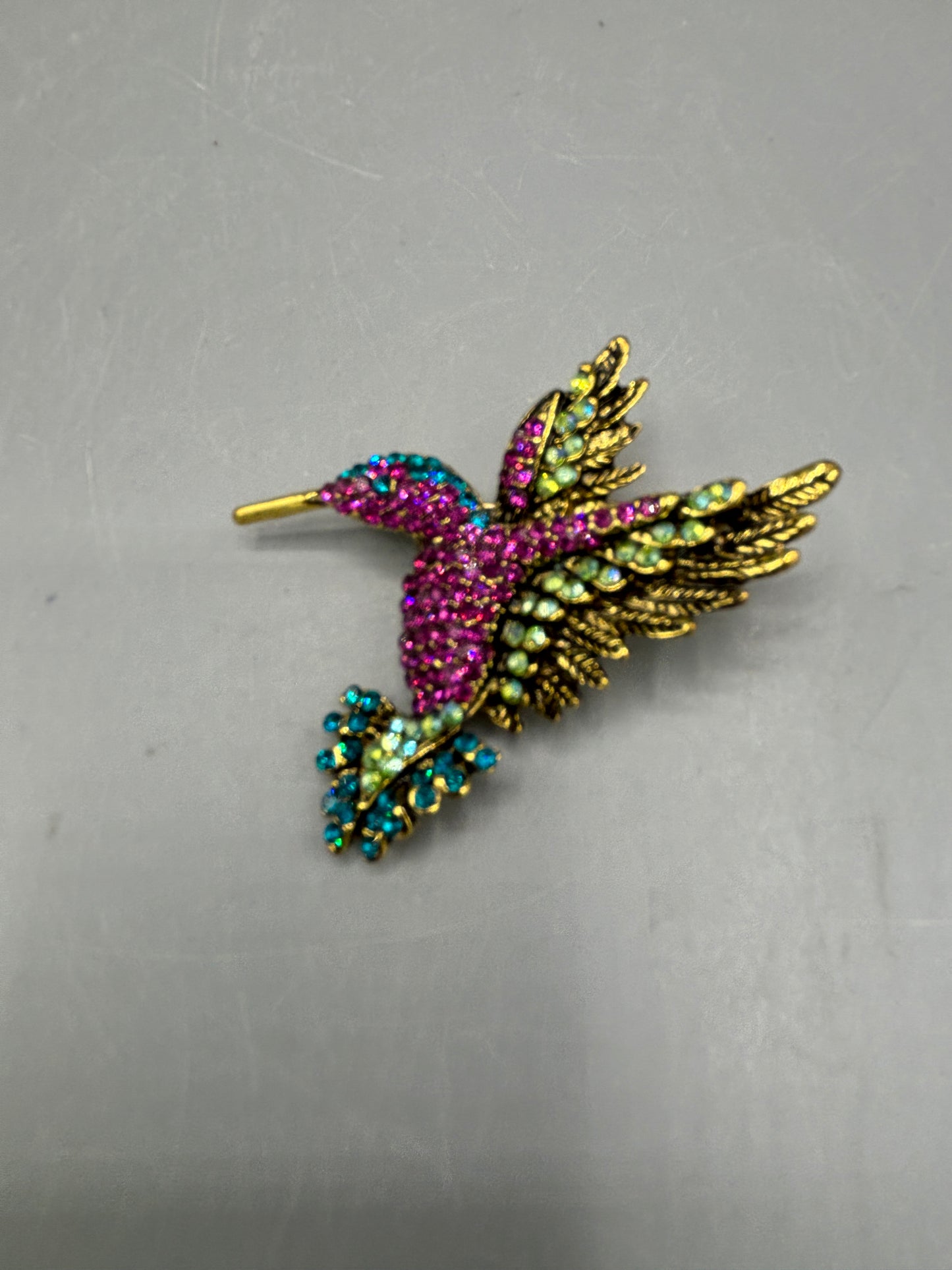 Gold tone multi jewel hummingbird brooch