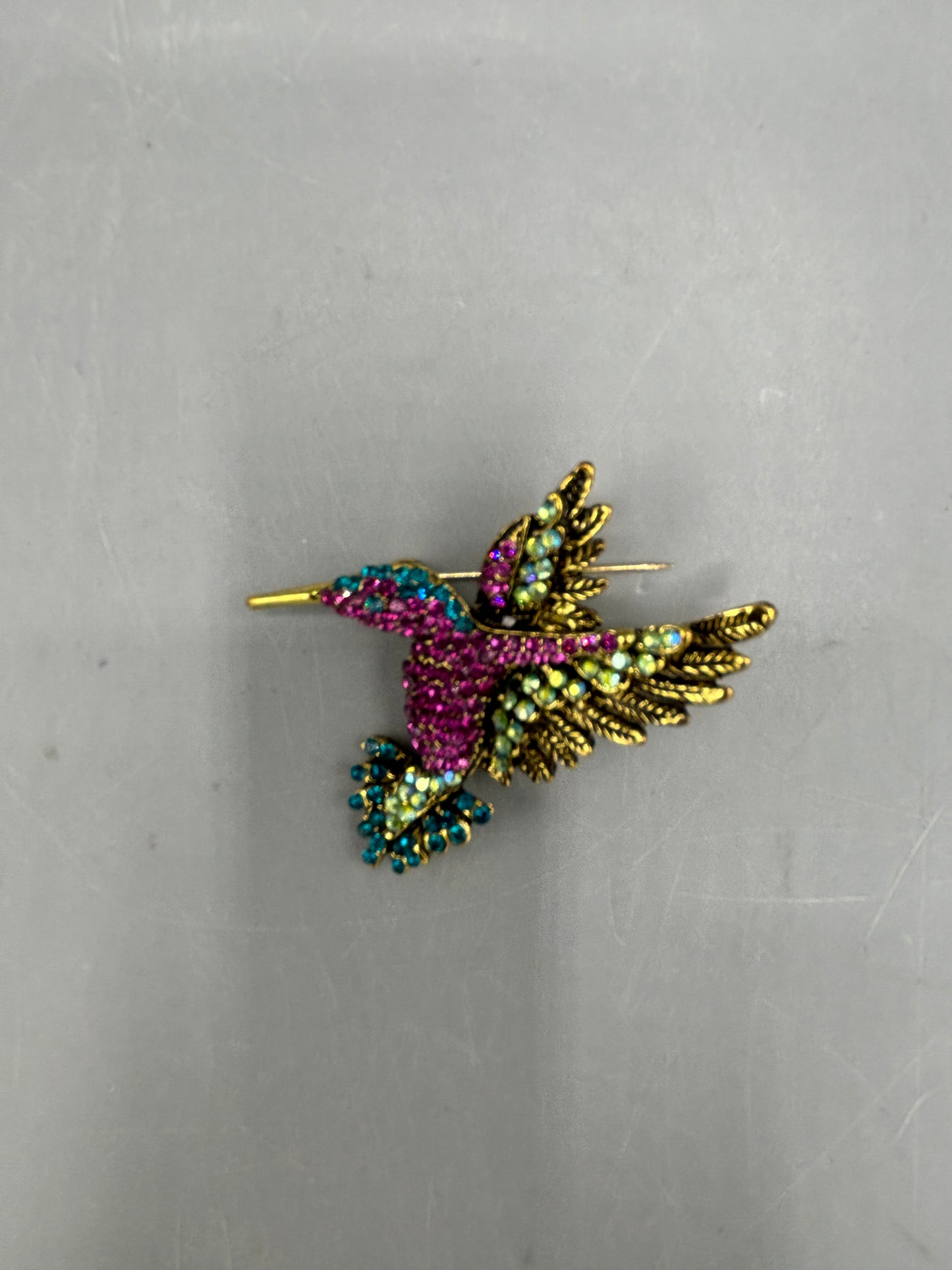 Gold tone multi jewel hummingbird brooch