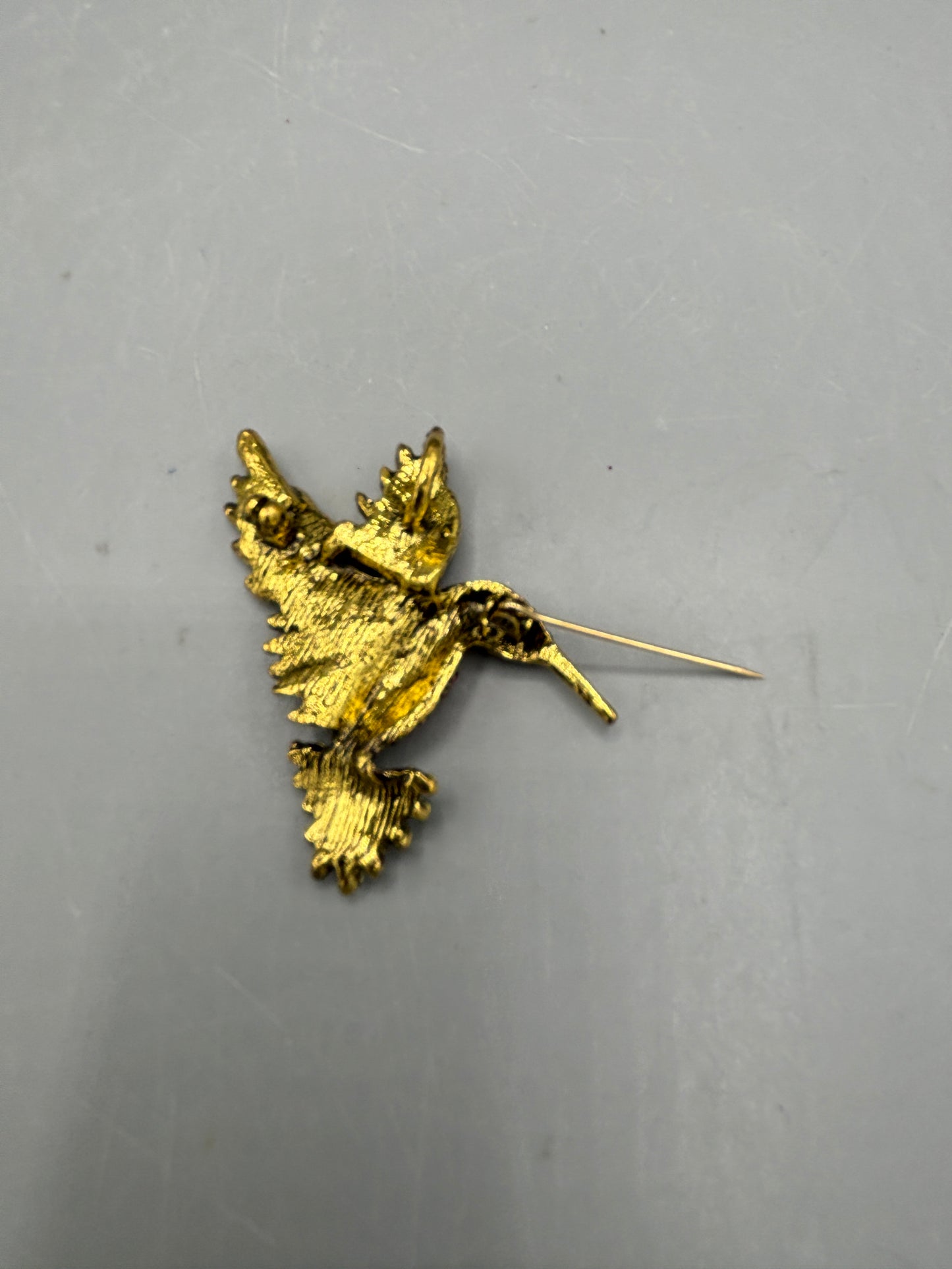 Gold tone multi jewel hummingbird brooch