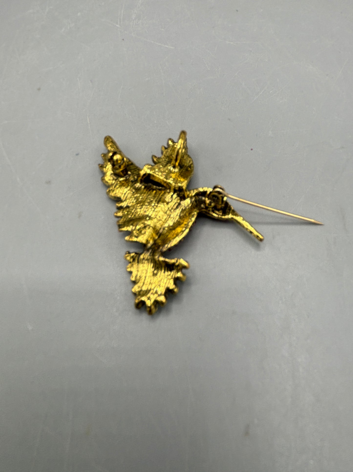 Gold tone multi jewel hummingbird brooch