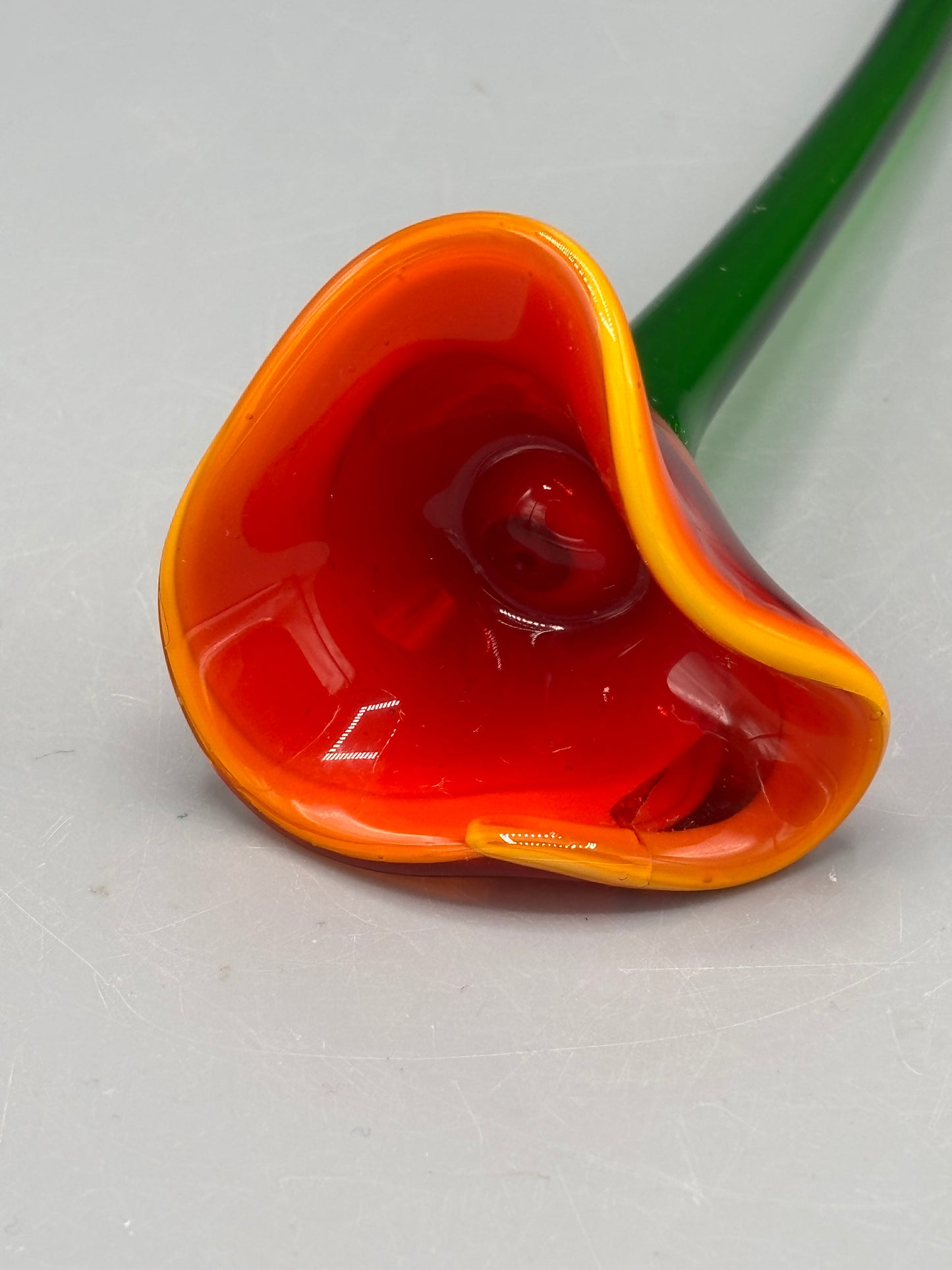 Art glass orange yellow with green stem