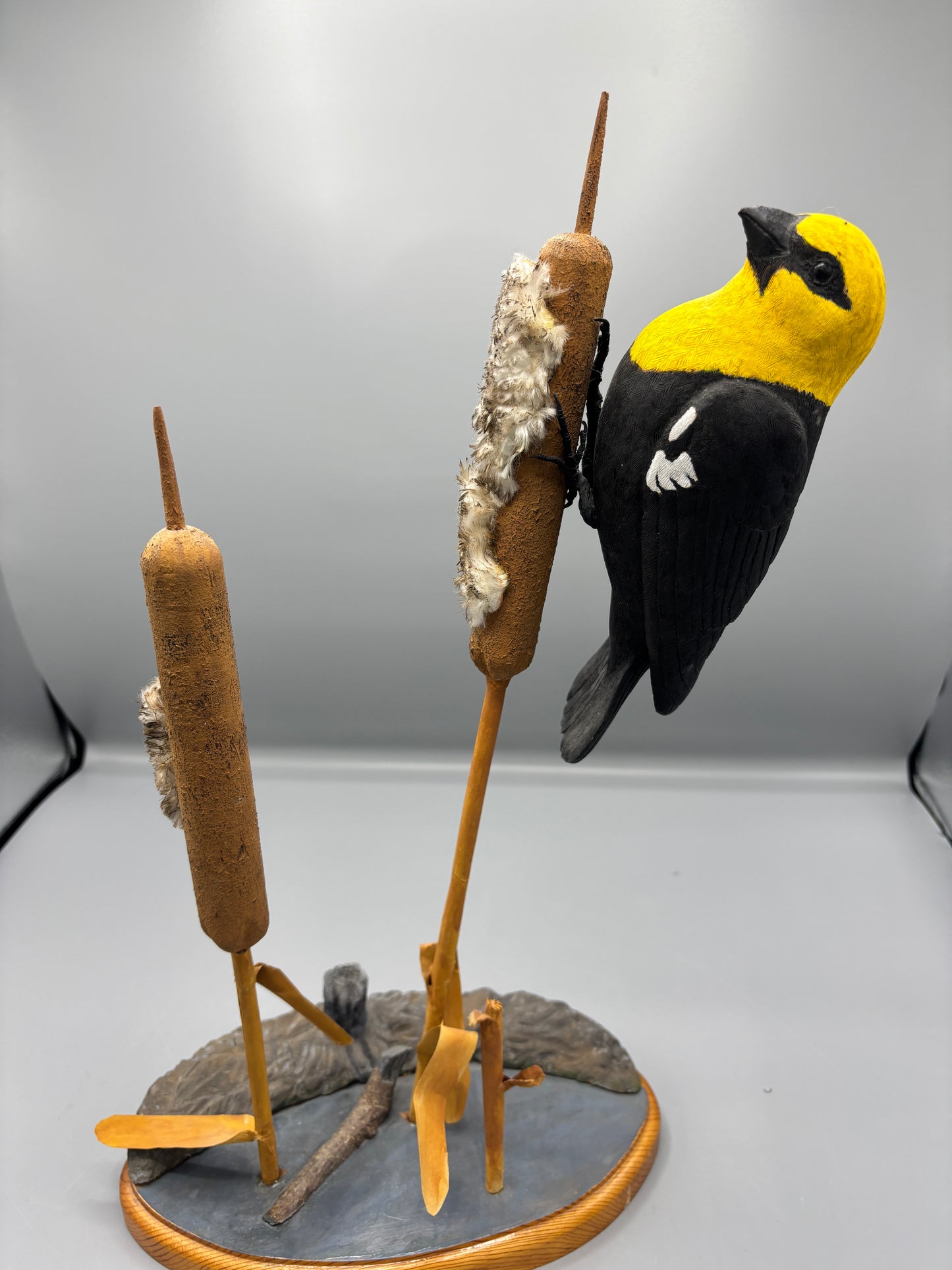 Yellow headed black bird wood carving