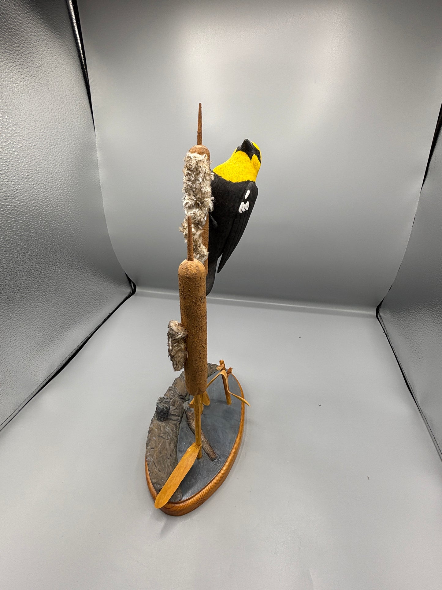 Yellow headed black bird wood carving
