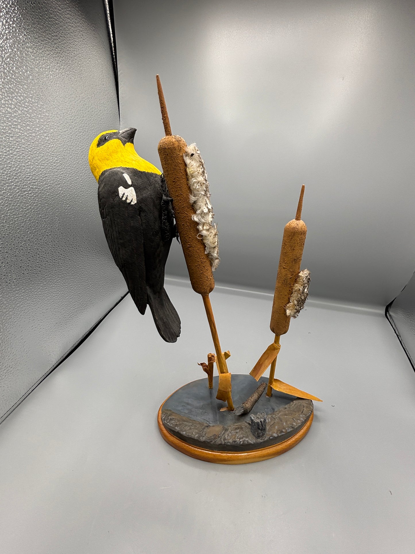 Yellow headed black bird wood carving