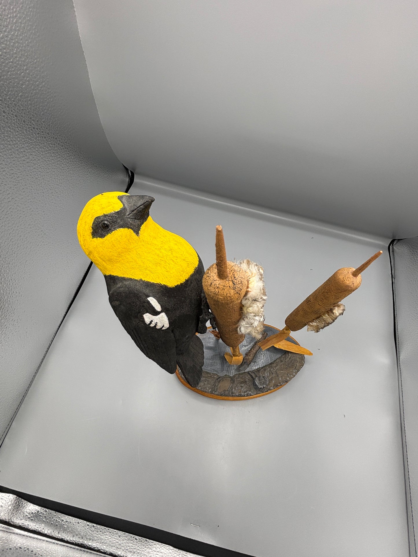 Yellow headed black bird wood carving
