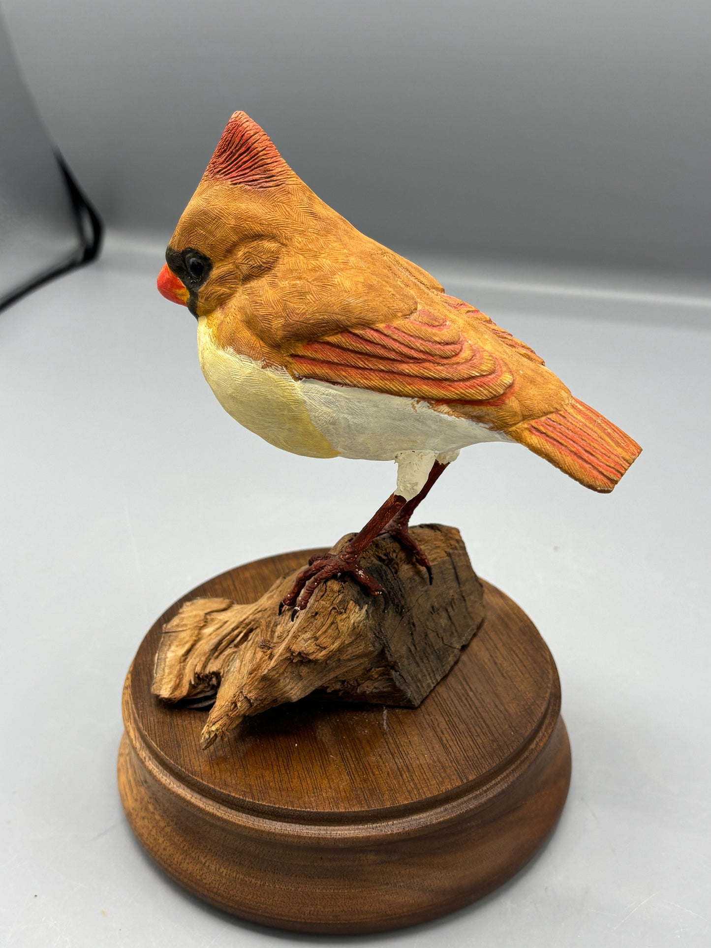 Female Cardinal bird on wood figure