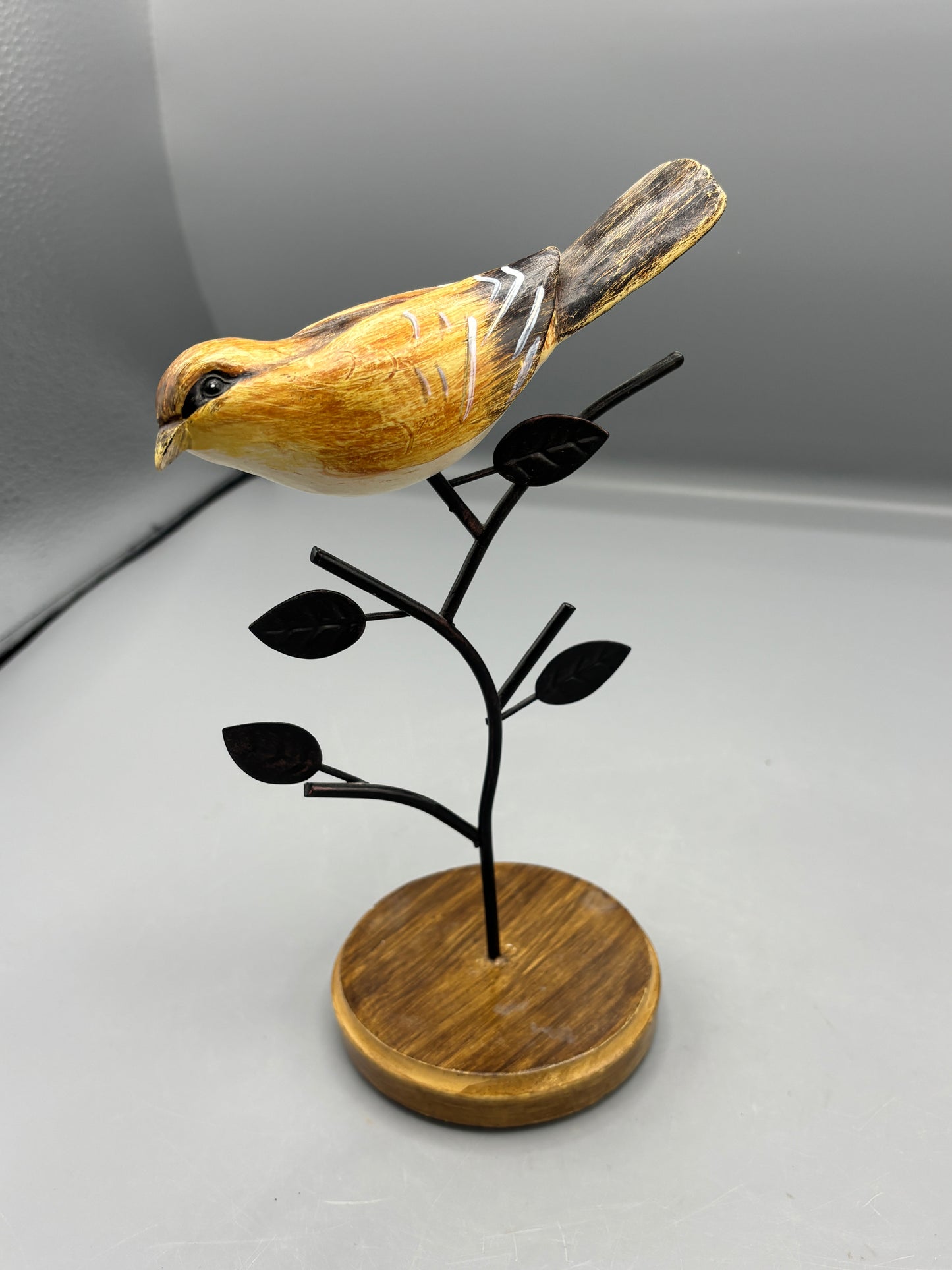 Carved Wren bird on metal branch