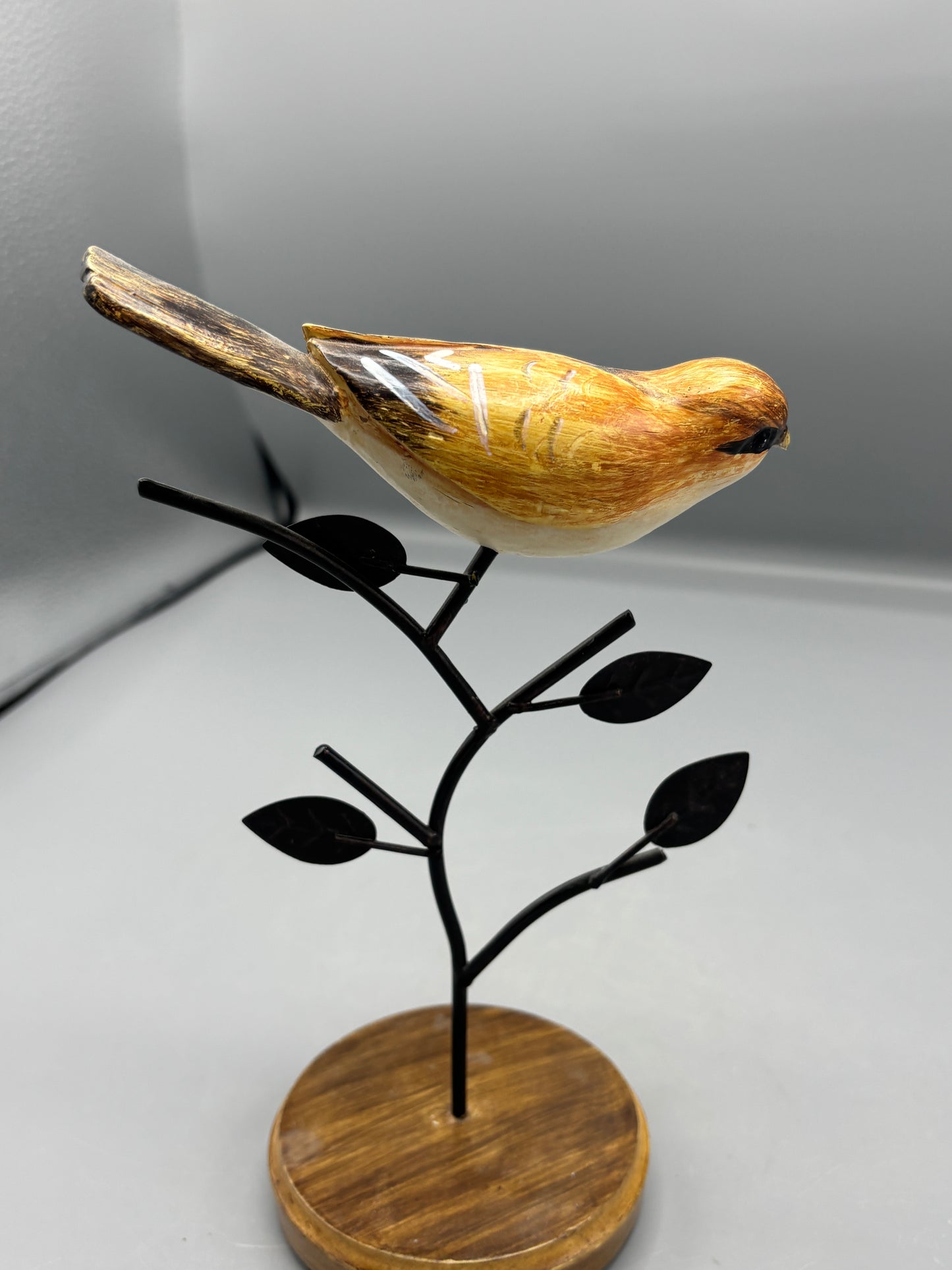 Carved Wren bird on metal branch